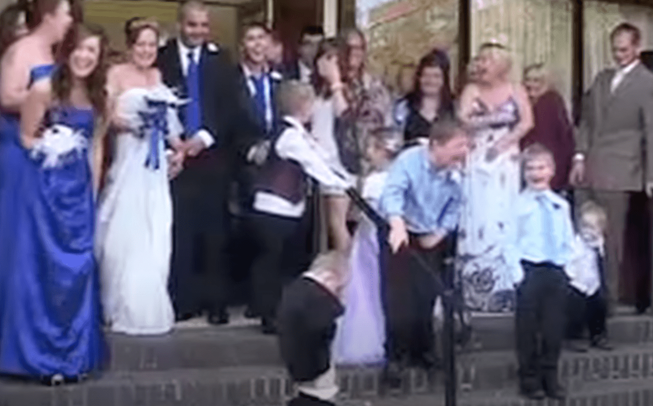 Young ring bearer relieves himself in the middle of a wedding photoshoot. | Source: youtube.com/thisishappening