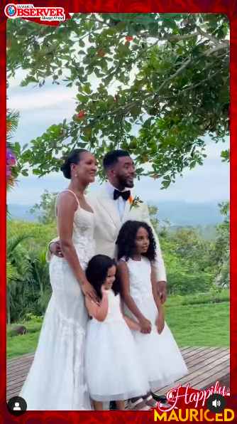 Stephanie Wash and Etienne Maurice posing for a picture with loved ones at their wedding, posted on July 13, 2024 | Source: Instagram/jamaicaobserver