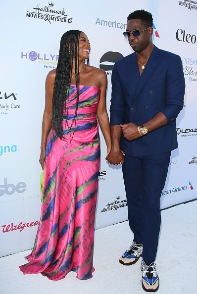 Gabrielle Union and husband, Dwyane Wade having a good time on the red carpet at the HollyRod Foundation's 21st Annual DesignCare Gala | Photo: Getty Images