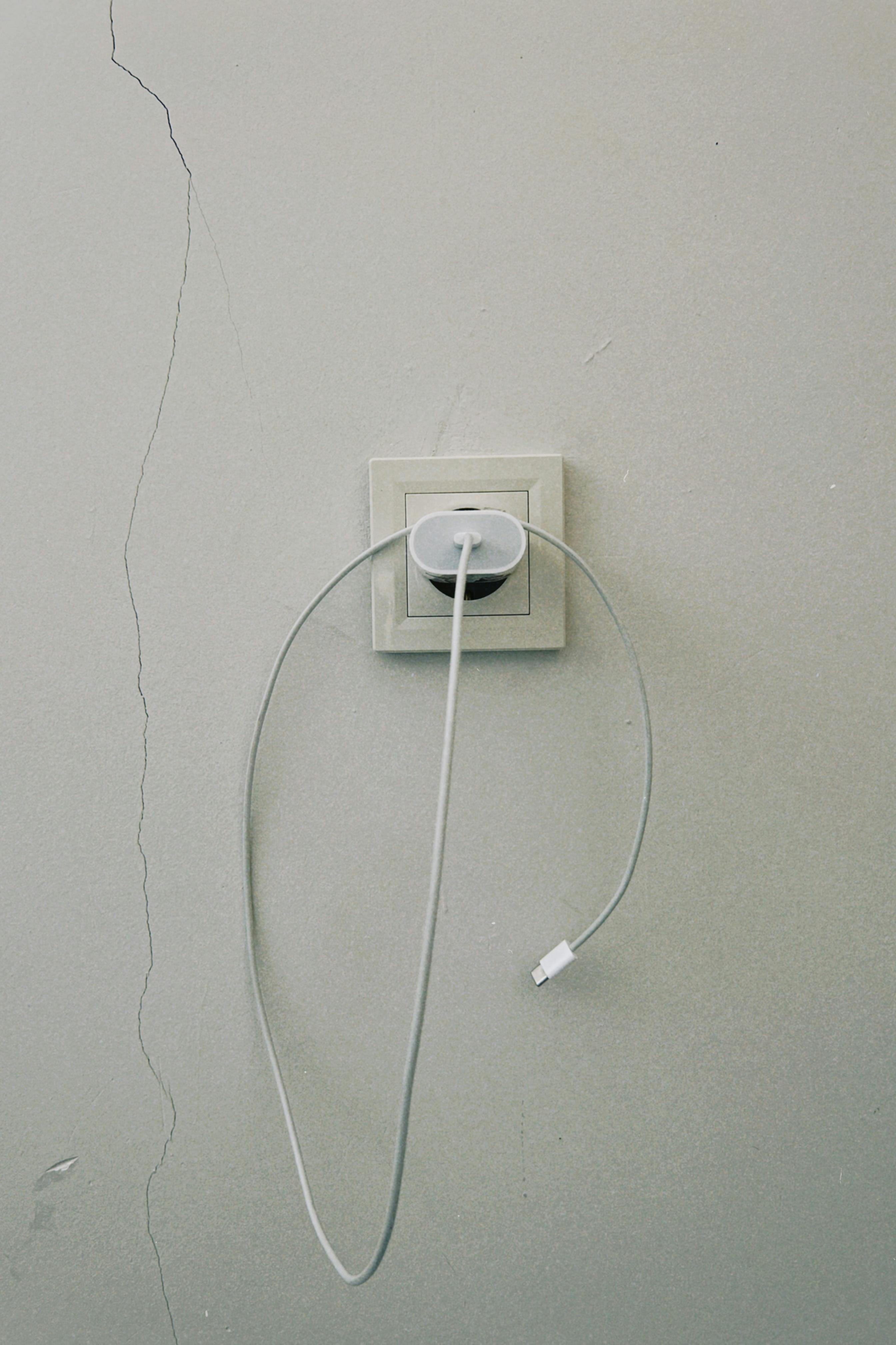 An iPhone charger plugged in | Source: Pexels