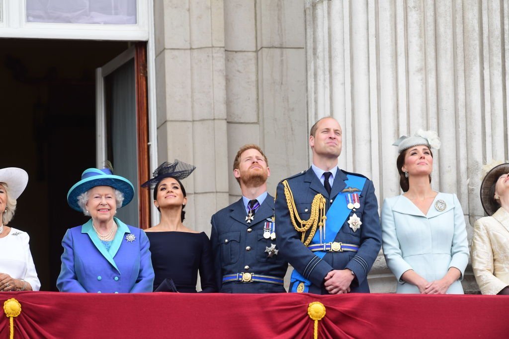 Queen Elizabeth II, Meghan Markle, Prince Harry, Prince William, Catherine, Duchess of Cambridge and Princess Anne, watch the RAF 100th anniversary flypast from the balcony of Buckingham Palace on July 10, 2018 | Photo: GettyImages
