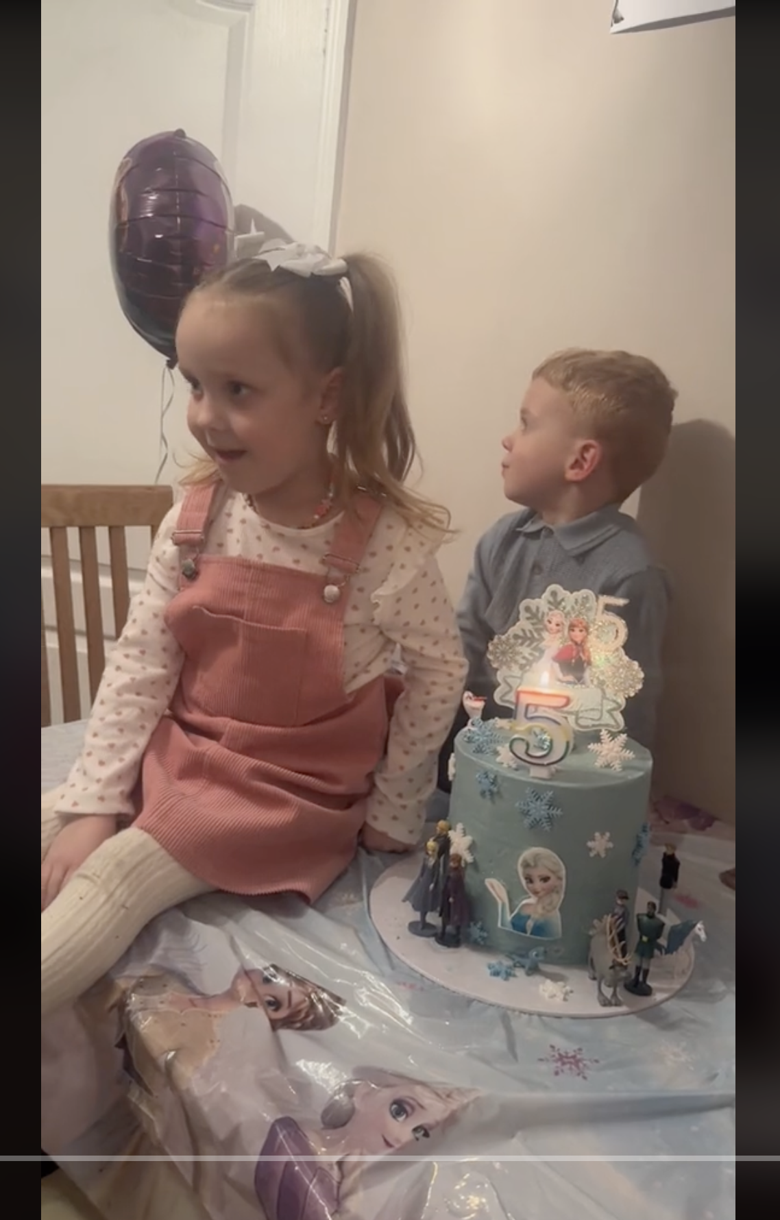 Ava and Leo are pictured sitting near the former's fifth birthday cake, as seen in a video dated December 26, 2023 | Source: tiktok.com/@bruh.georgia