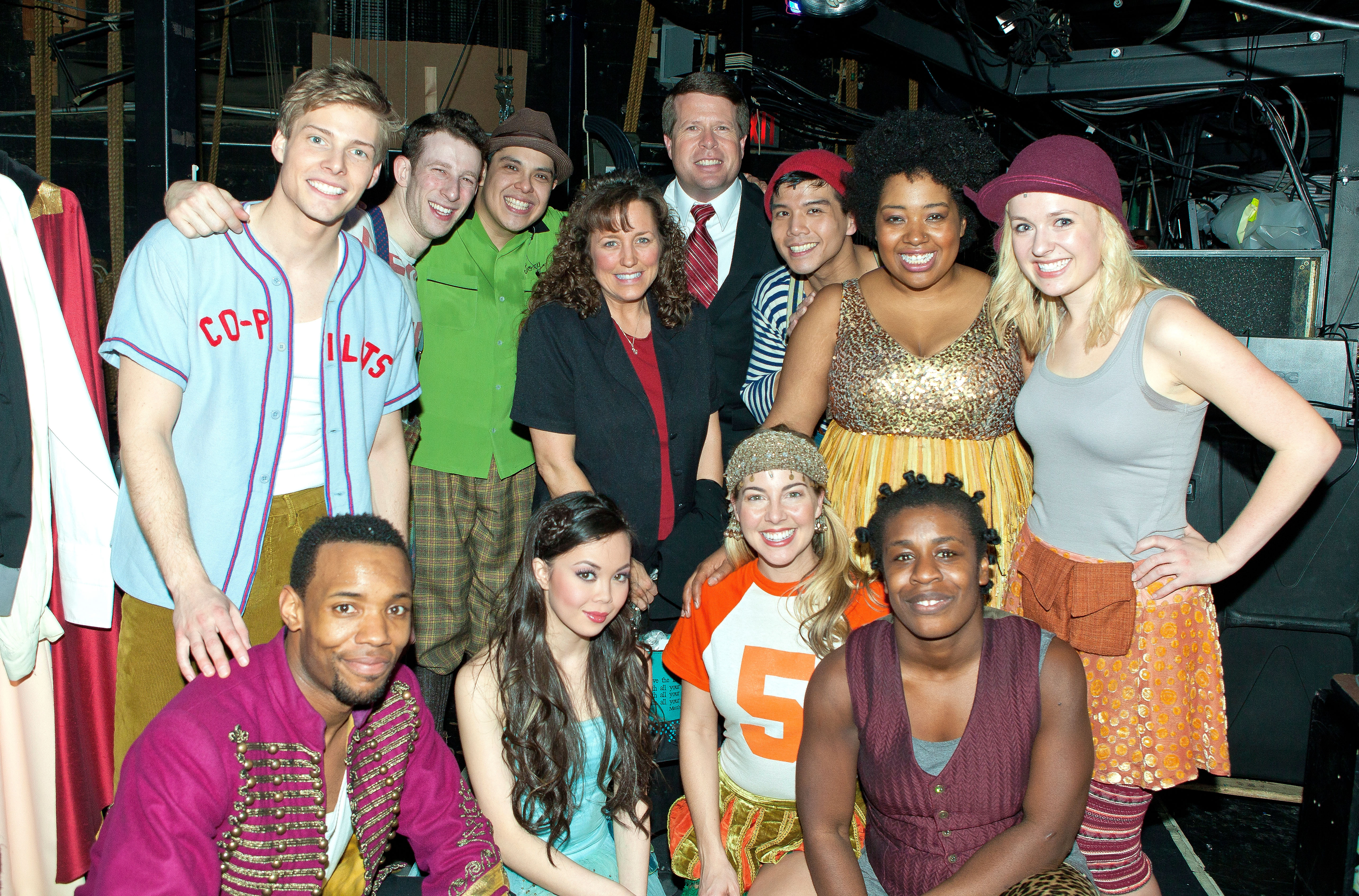 Jim Bob Duggar and Michelle Duggar from "19 Kids and Counting" pose with the cast backstage at the hit musical "Godspell" on Broadway in New York City, on February 16, 2012. | Source: Getty Images