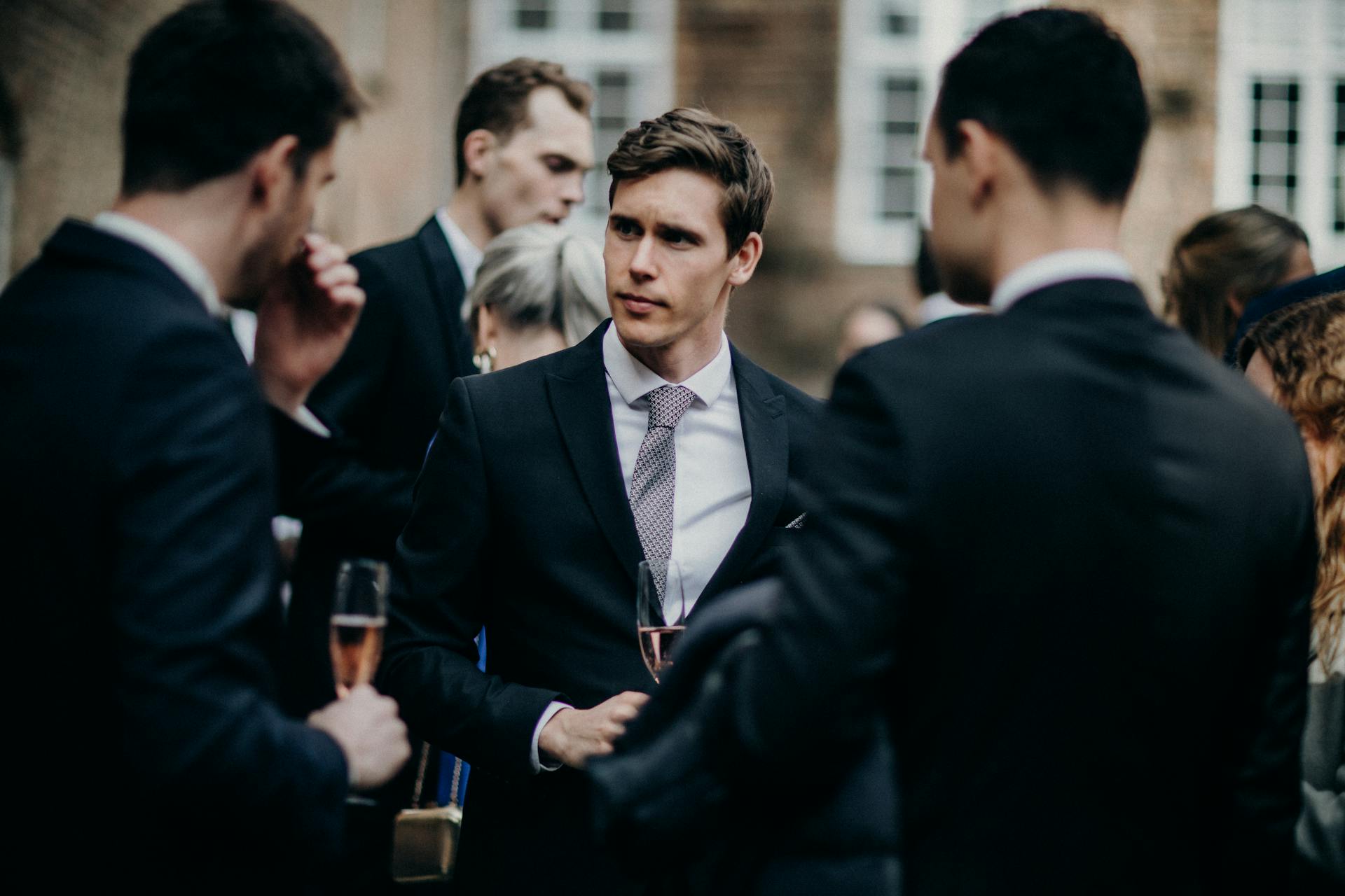 Men in suits talking at a party | Source: Pexels