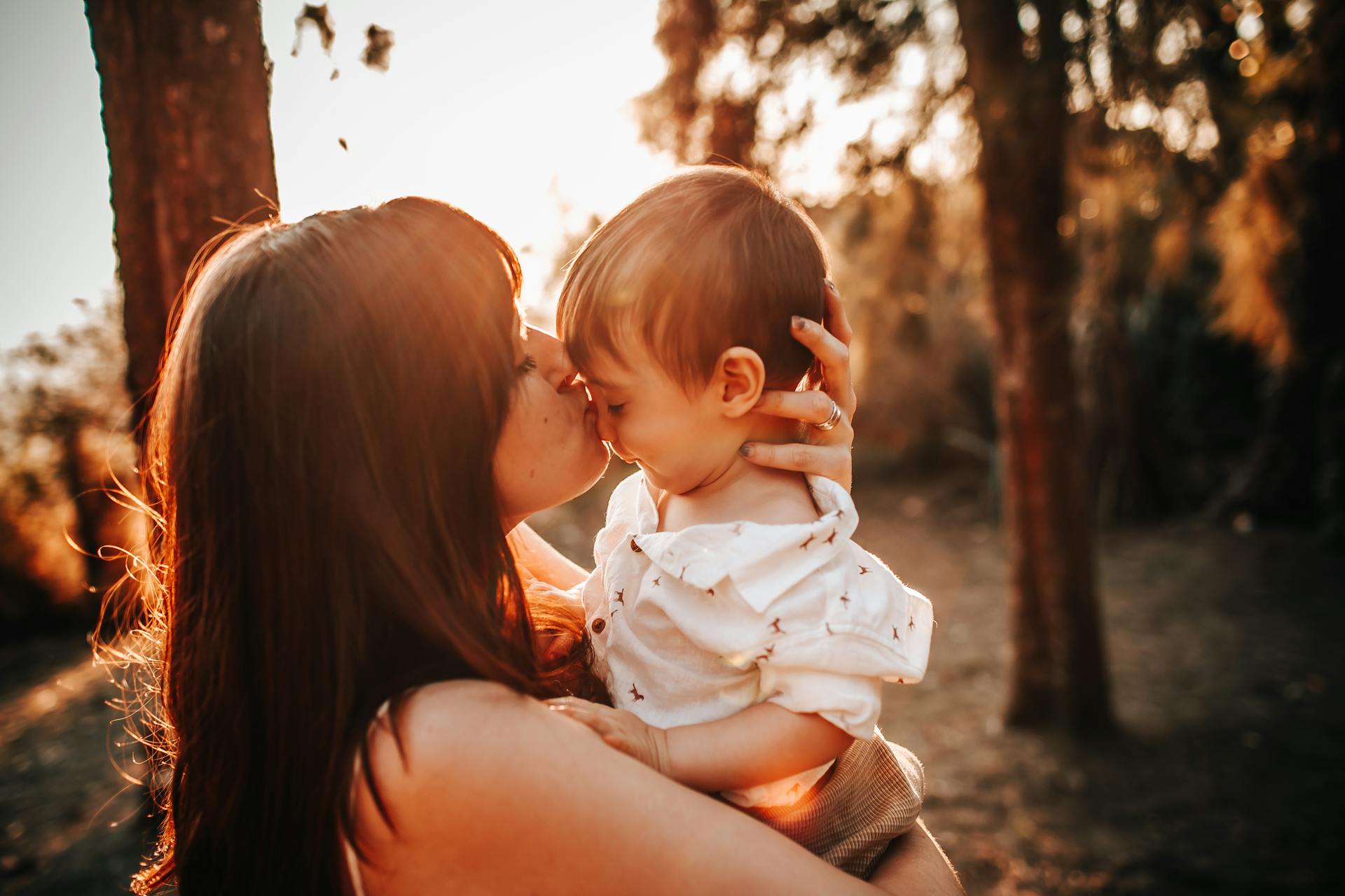 A woman kissing her baby boy | Source: Pexels