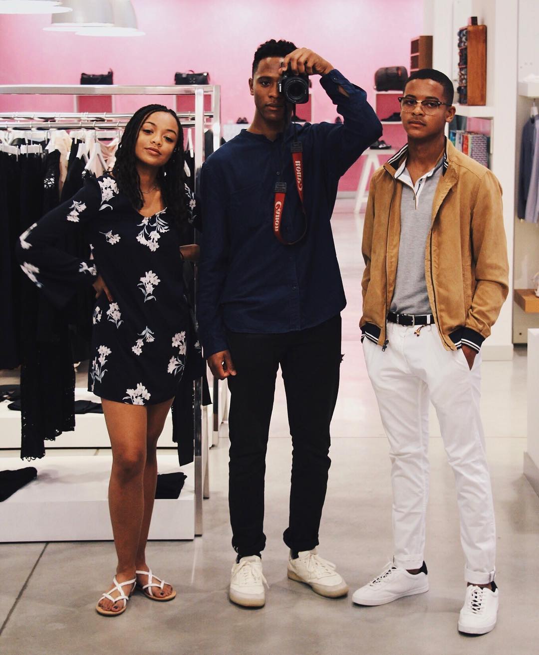 Blake Underwood (right) stands with his sister Brielle Underwood and brother Paris Underwood in a retail space, as Paris holds a camera while they pose casually together. | Source: Instagram/brielleunderwood