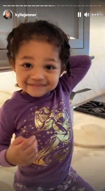 Kylie Jenner's daughter Stormi smiling at the camera while making pancakes with her mother. | Source: Instagram/kyliejenner