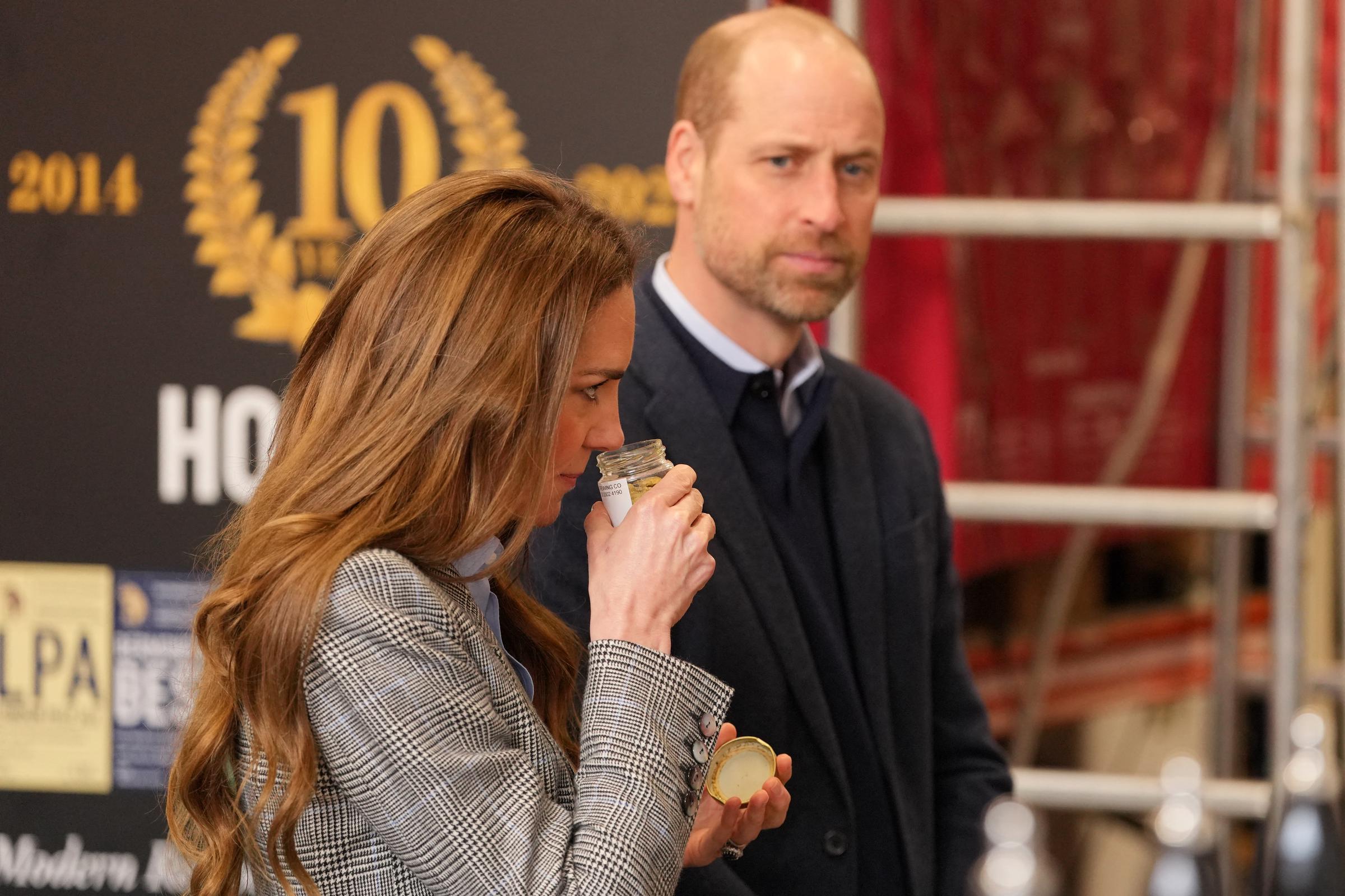 With Prince William looking on behind her, the Princess of Wales leans in to smell what appears to be a jar of brewing ingredients during the couple's visit to the Southwark Brewing Company on 12 March 2026. The moment captures a lighter side of what turned out to be a rather eventful afternoon — one that also produced a memorable verdict from the Prince of Wales.