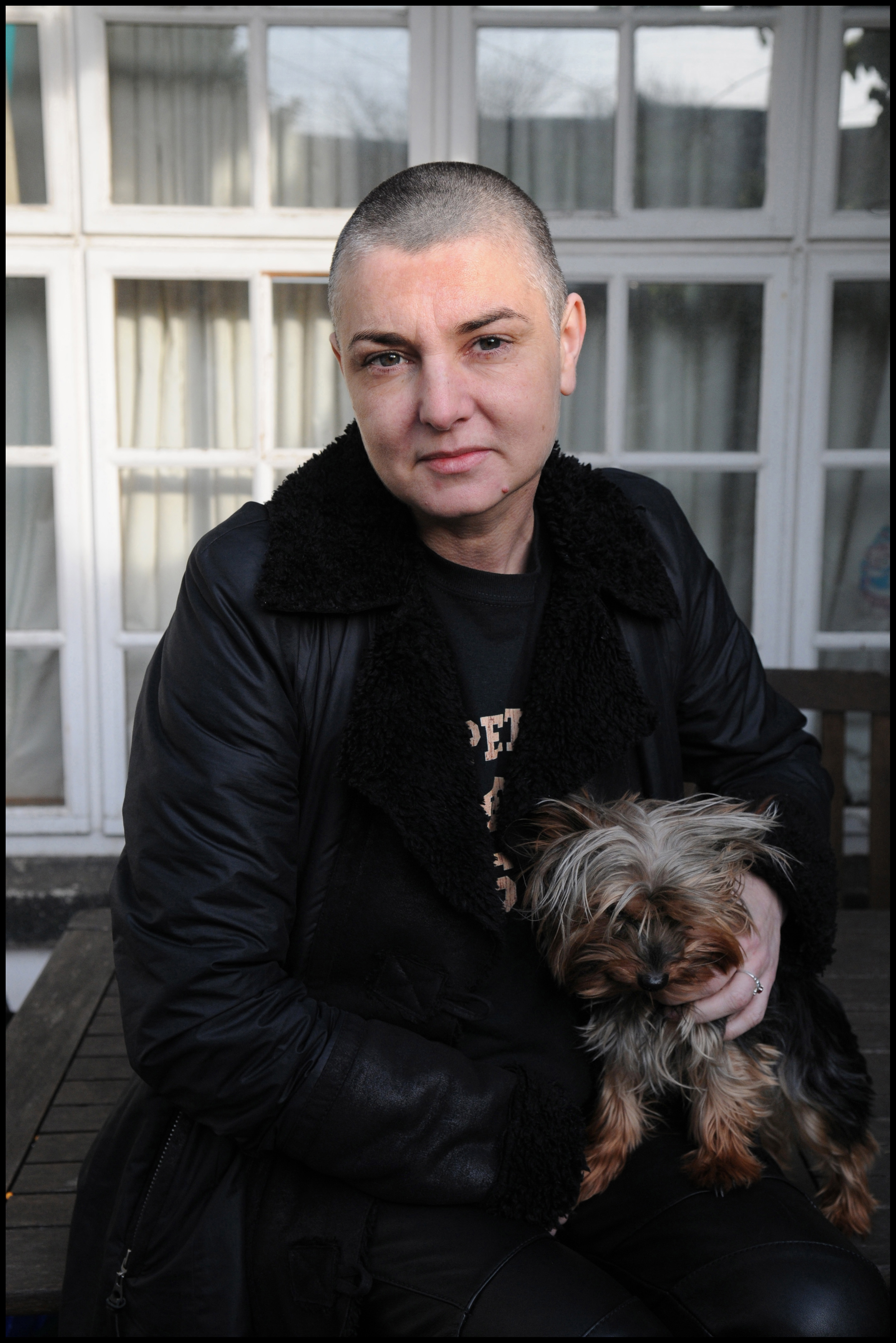 Sinéad O'Connor posing with her dog at her home in County Wicklow, Ireland, on February 3, 2012 | Source: Getty Images