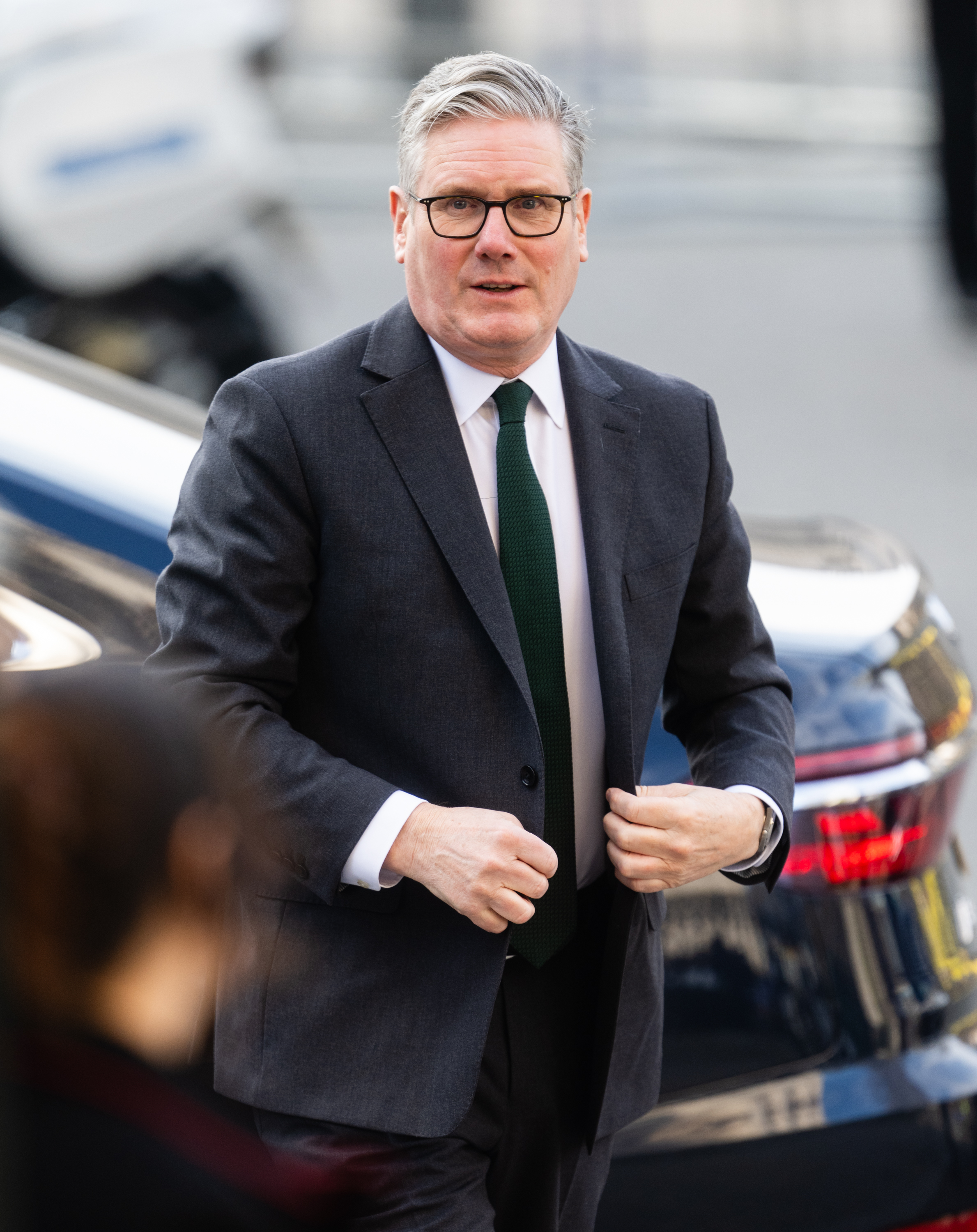 Prime Minister Sir Keir Starmer, in a charcoal suit and dark green knitted tie, buttoned his jacket as he strode purposefully from his car outside Westminster Abbey on 9 March 2026, stepping away from the ongoing Iran crisis to represent the British government at the Commonwealth Day service in central London.