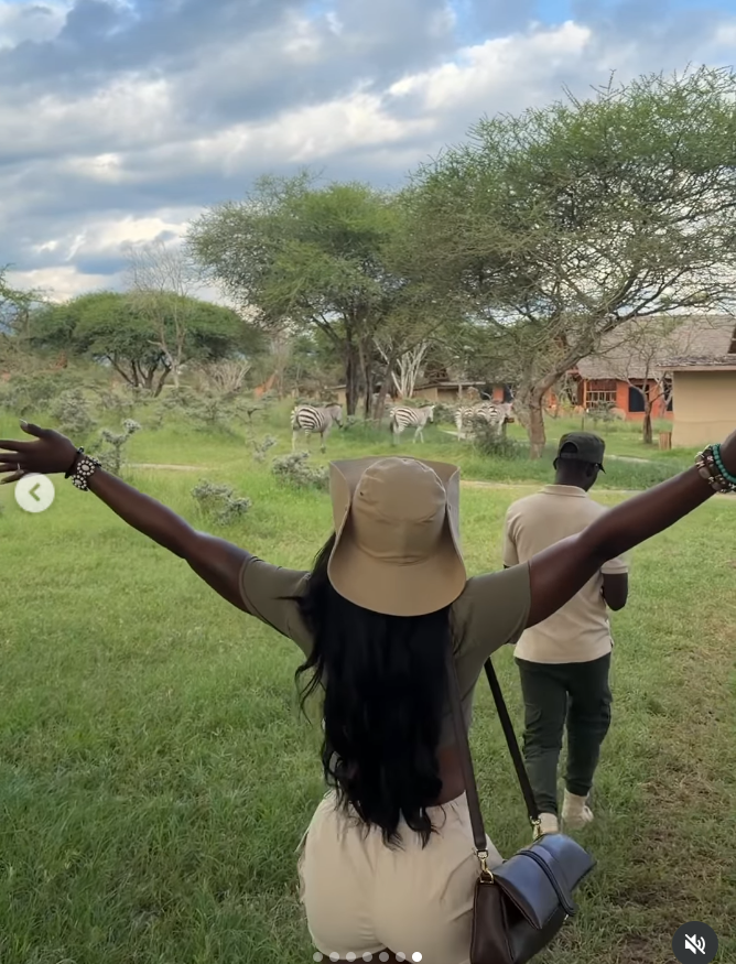 With her arms stretched wide toward the horizon, Ashly Robinson embraces the open savannah, her silhouette capturing a quiet, freeing moment. | Source: Instagram/ashleejenae