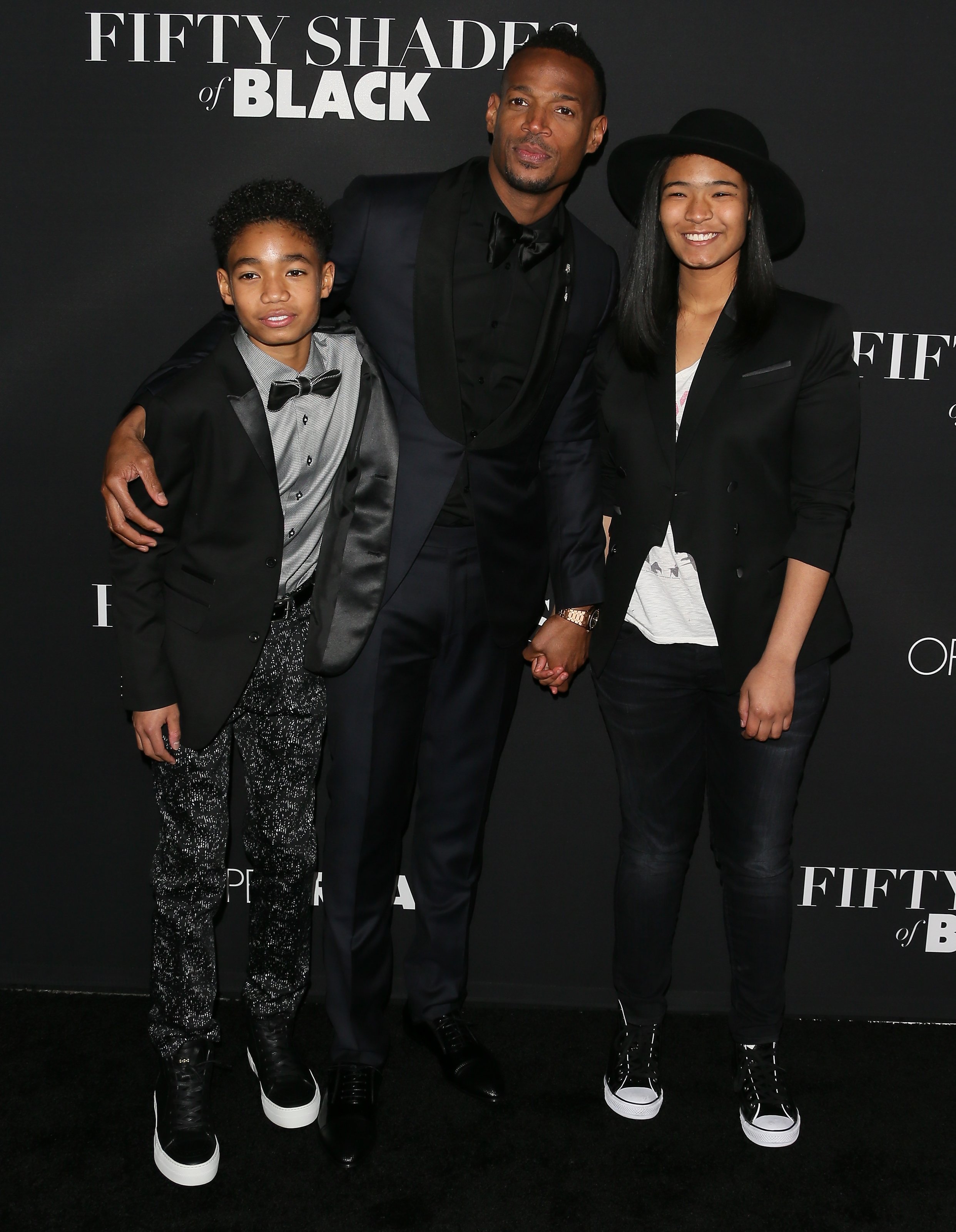 Marlon Wayans, son Shawn, and daughter Amai arrive for the premiere of Open Roads Films' "Fifty Shades Of Black" on January 26, 2016, in Los Angeles, California. | Source: Getty Images