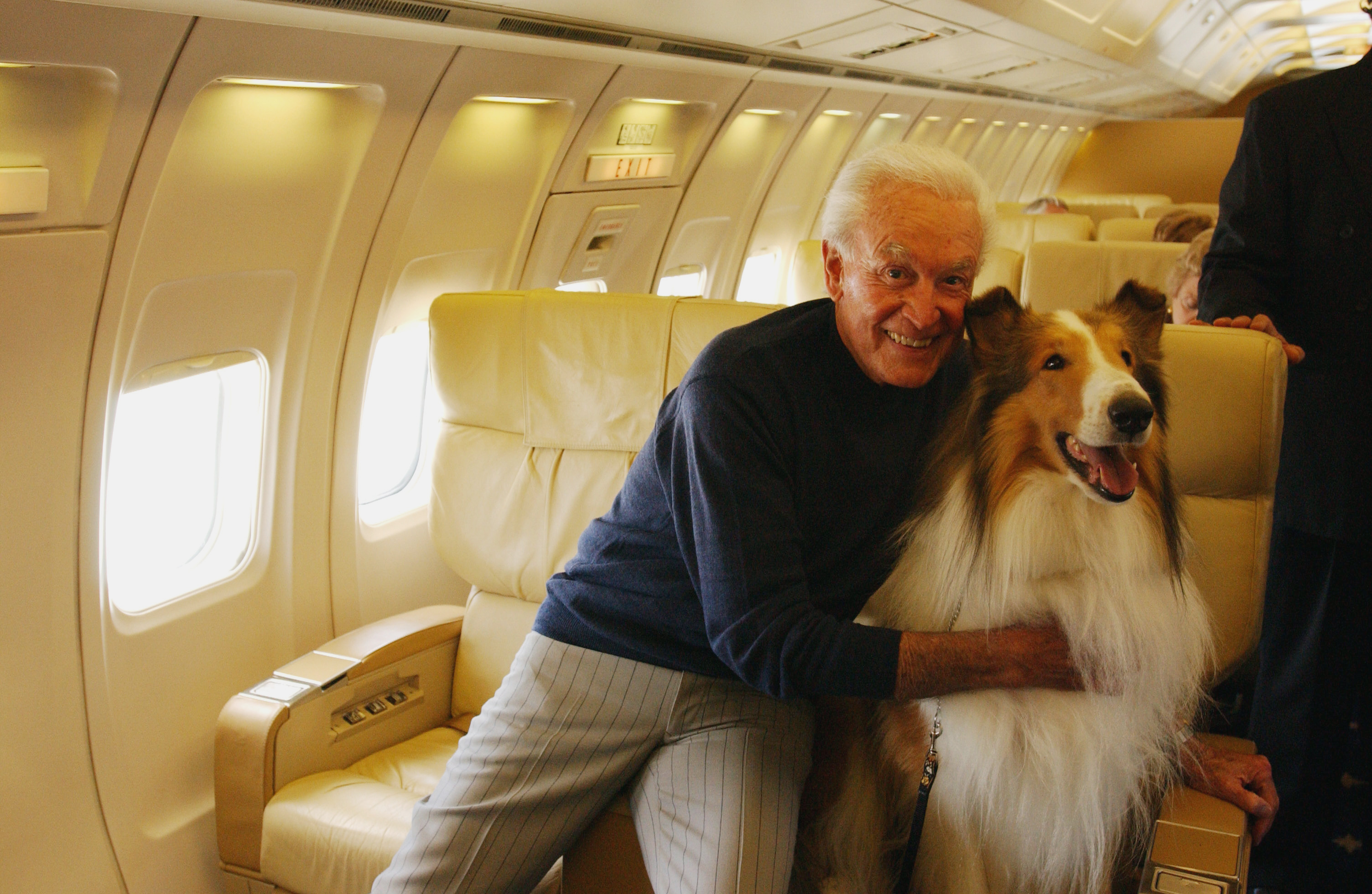 Howard, best known as Lassie, poses with American television personality and game show host Bob Barker on a chartered aircraft, Los Angeles, California, October 31, 2003. | Source: Getty Images