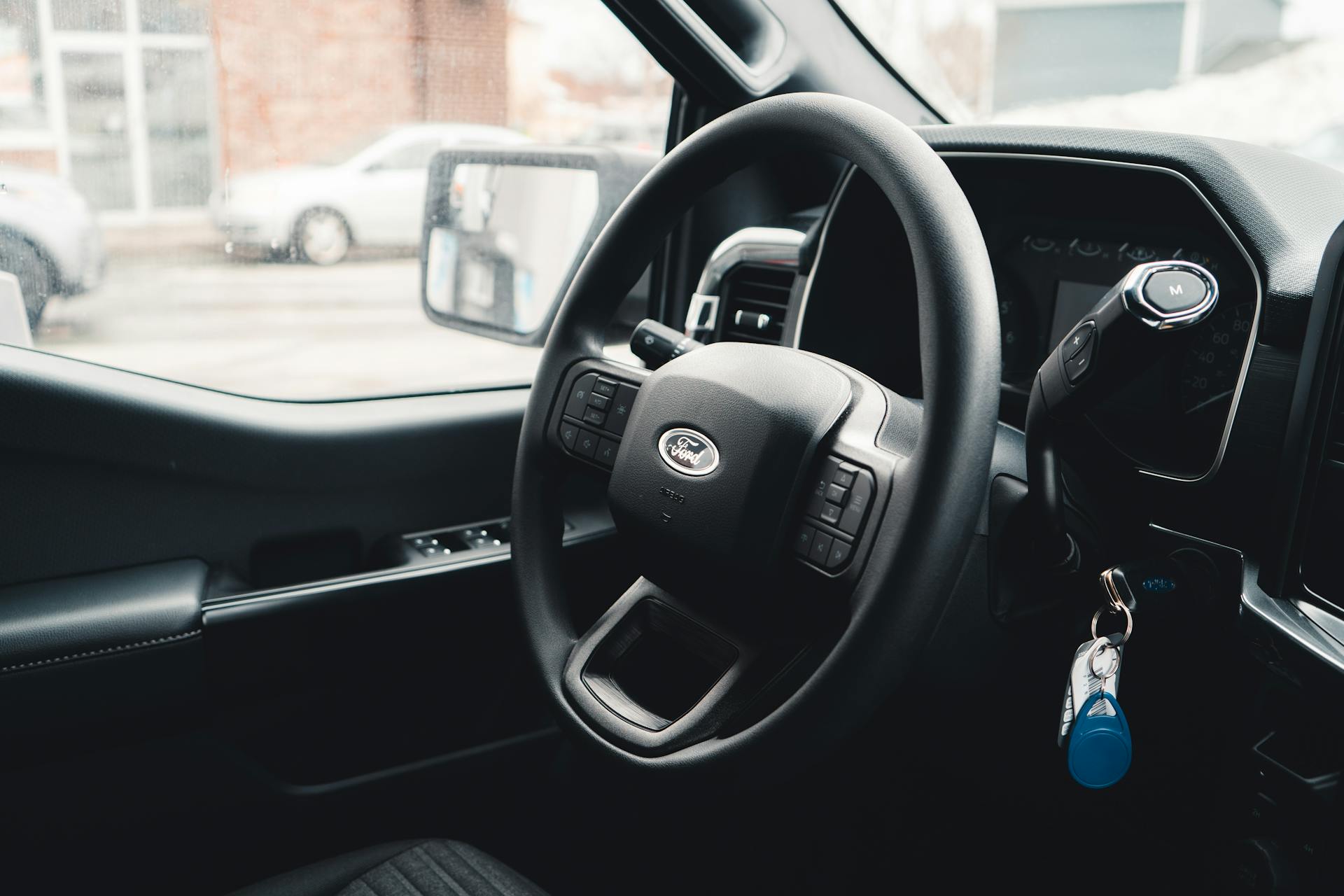 The interior of a car with keys in the ignition switch | Source: Pexels