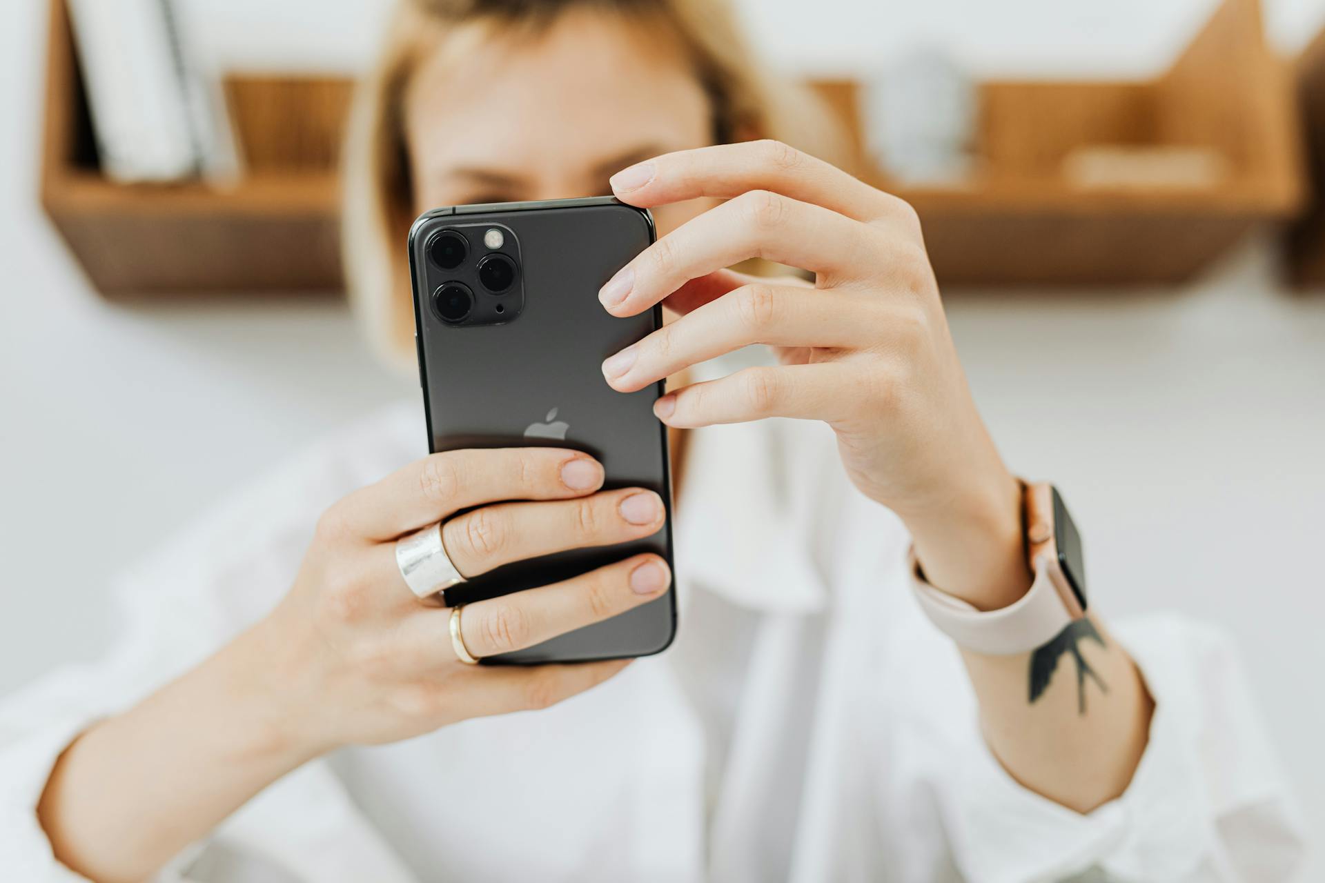 A woman holding her phone | Source: Pexels