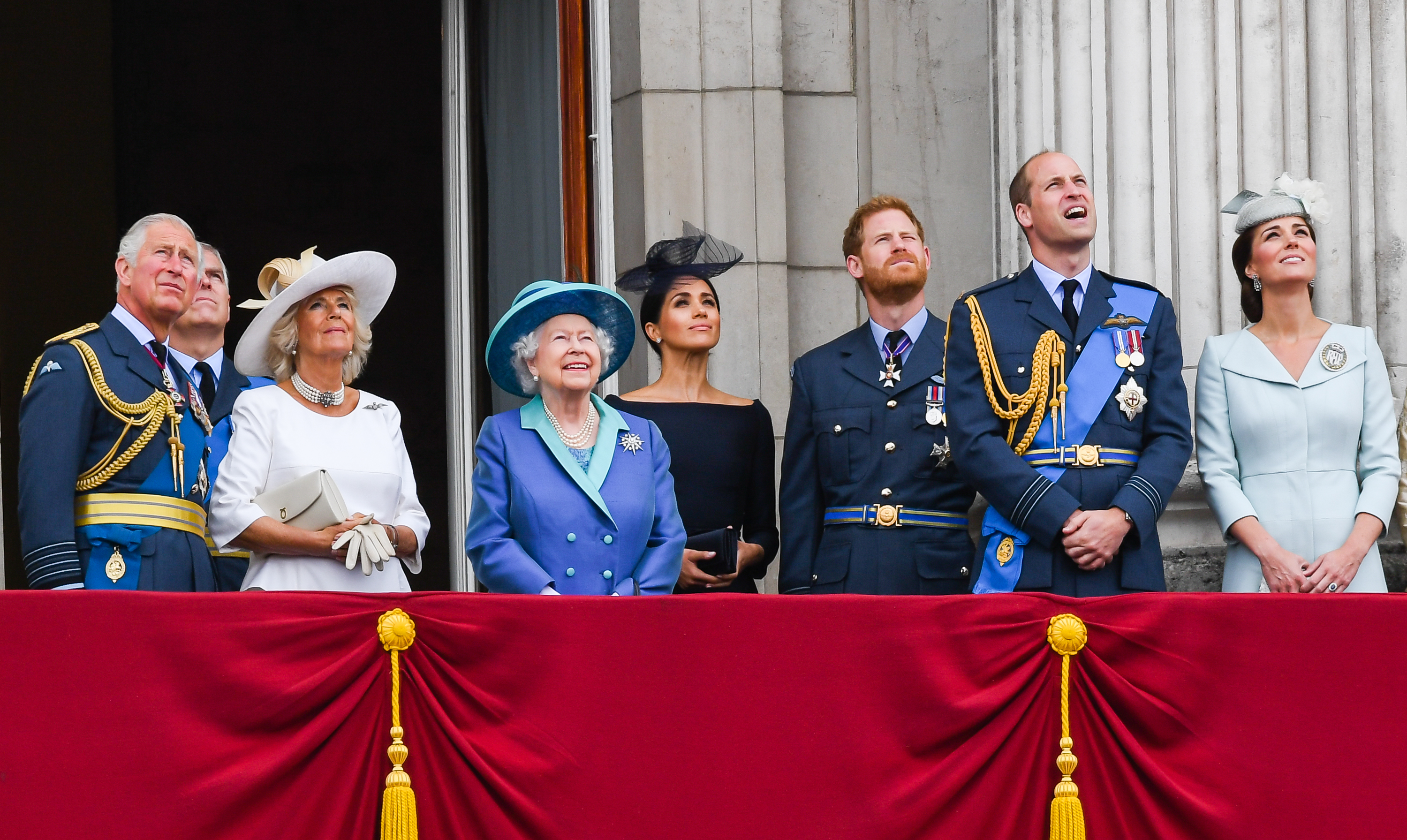 King Charles, Camilla, Queen Elizabeth ll, Meghan, Prince Harry, Prince William, and Catherine, stand on the balcony of Buckingham Palace to view a flypast to mark the centenary of the Royal Air Force (RAF) | Source: Getty Images