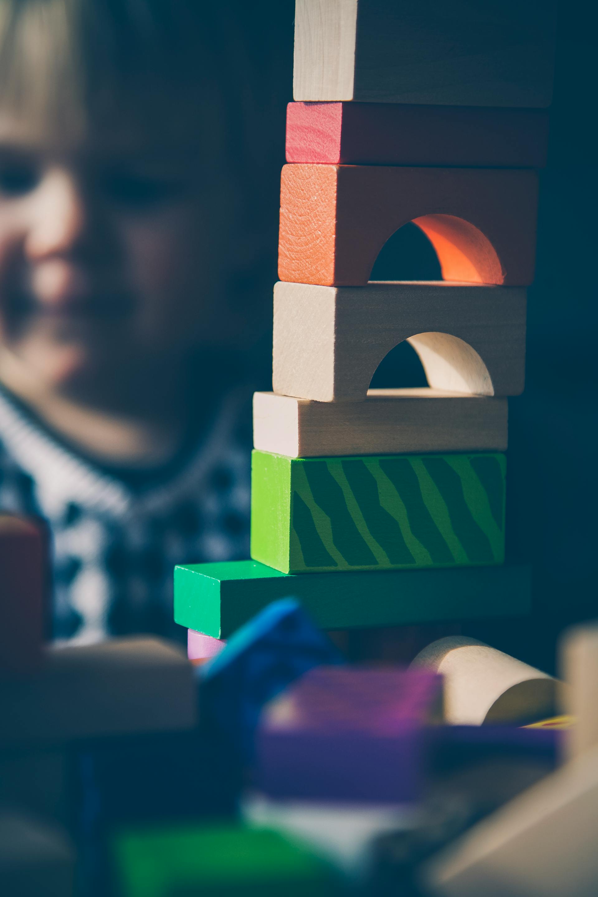 A child playing with colored blocks | Source: Pexels
