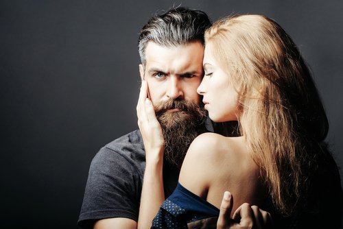 A young bearded man held by a young blond woman. | Source: Shutterstock. A young bearded man held by a young blond woman. | Source: Shutterstock.