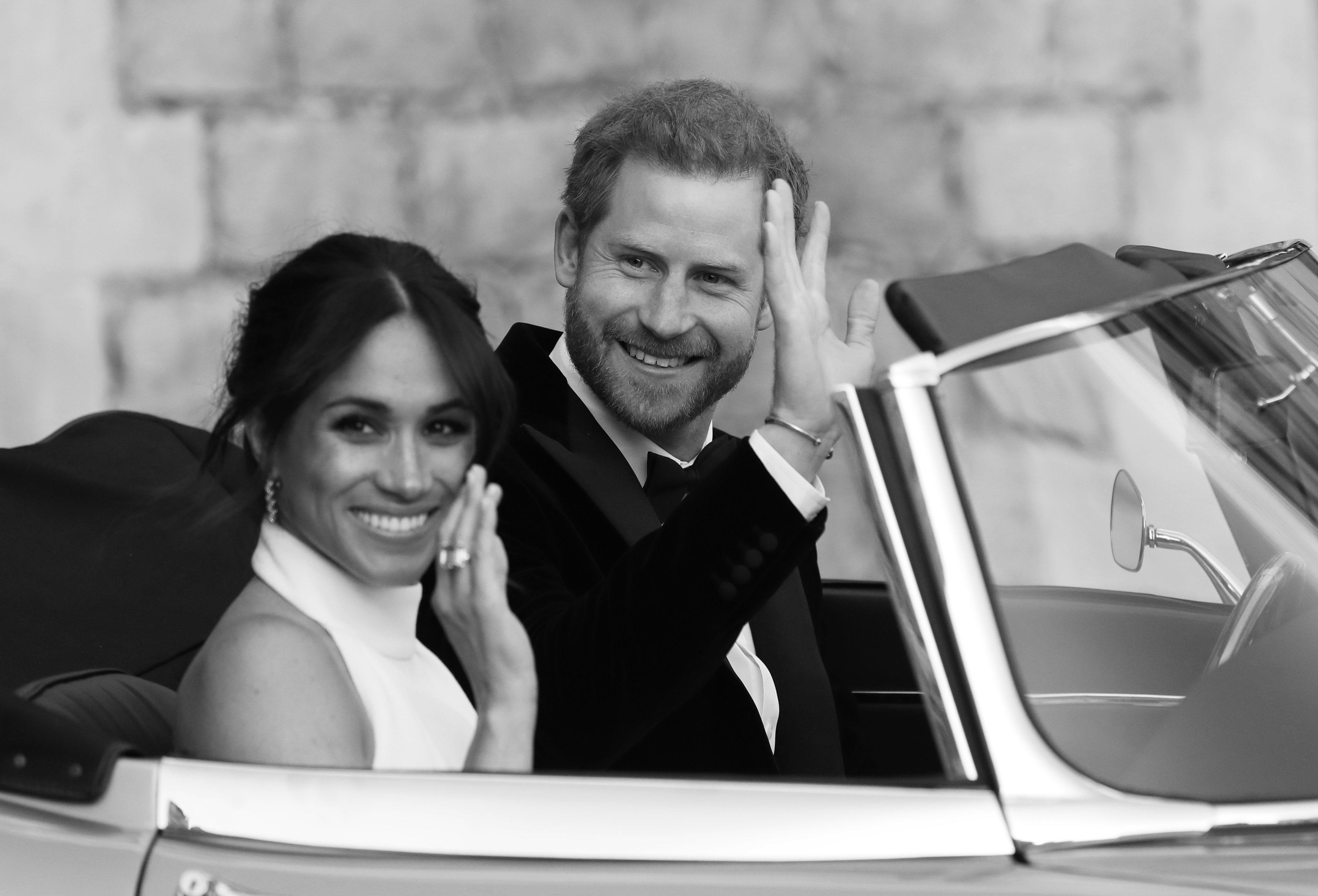 Prince Harry and Meghan Markle leave Windsor Castle in Windsor on May 19, 2018 in an E-Type Jaguar after their wedding to attend an evening reception at Frogmore House | Source: Getty Images 