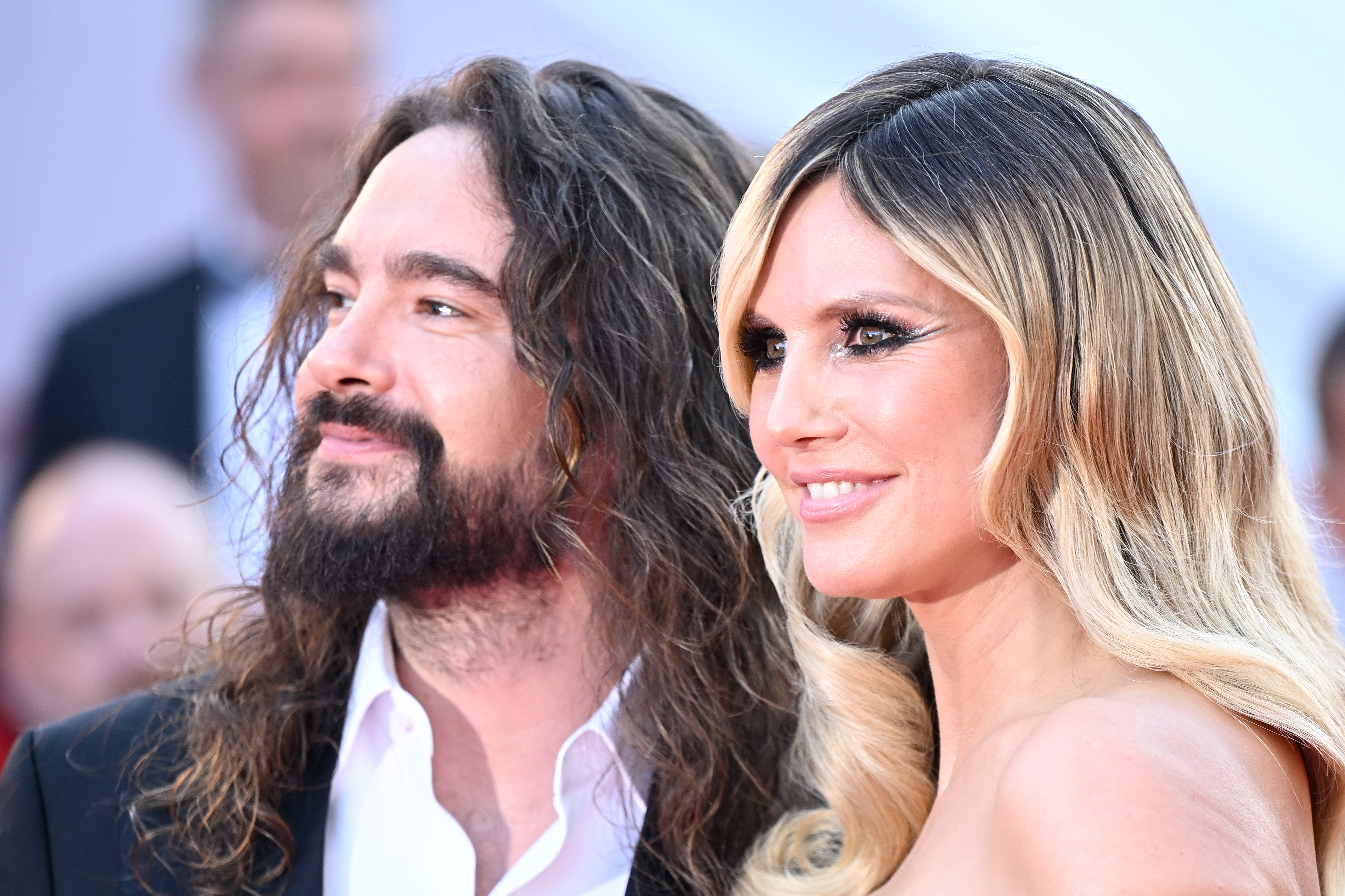 In a shoulder-up shot, the striking contrast between Kaulitz's jet-black hair and Klum's flowing blonde waves creates a captivating visual harmony. Their features complement each other effortlessly, blending beauty and handsomeness into a picture that radiates elegance and chemistry.