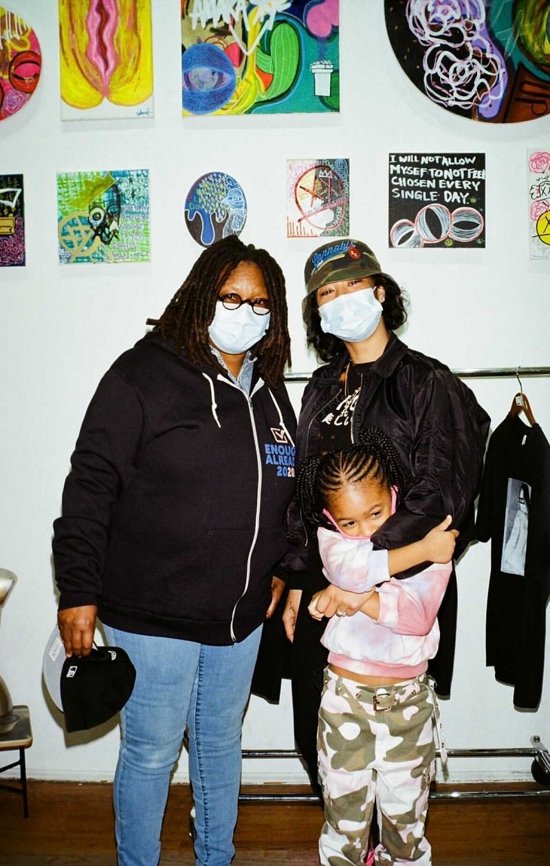 Amara Skye, her daughter Charli, and grandmother Whoopi Goldberg posing in front of some of Skye's paintings | Photo: Courtesy of Amara Skye