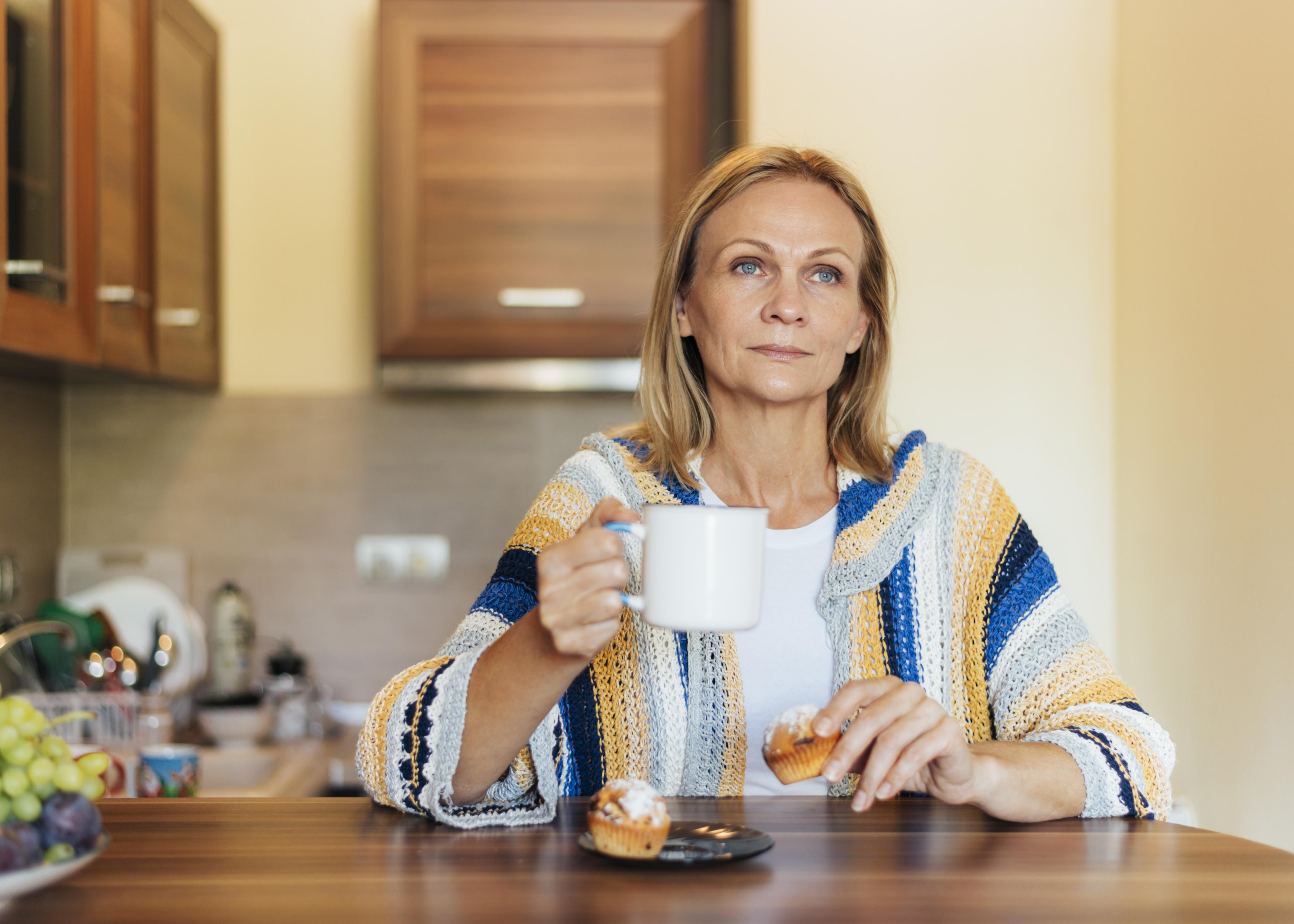 Woman in the kitchen with a cup of tea | Source: Freepik