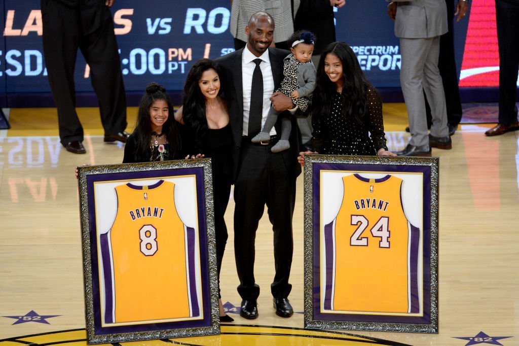 Kobe Bryant poses with his family at halftime after both his #8 and #24 Los Angeles Lakers jerseys are retired at Staples Center in Los Angeles, California | Photo: Getty Images