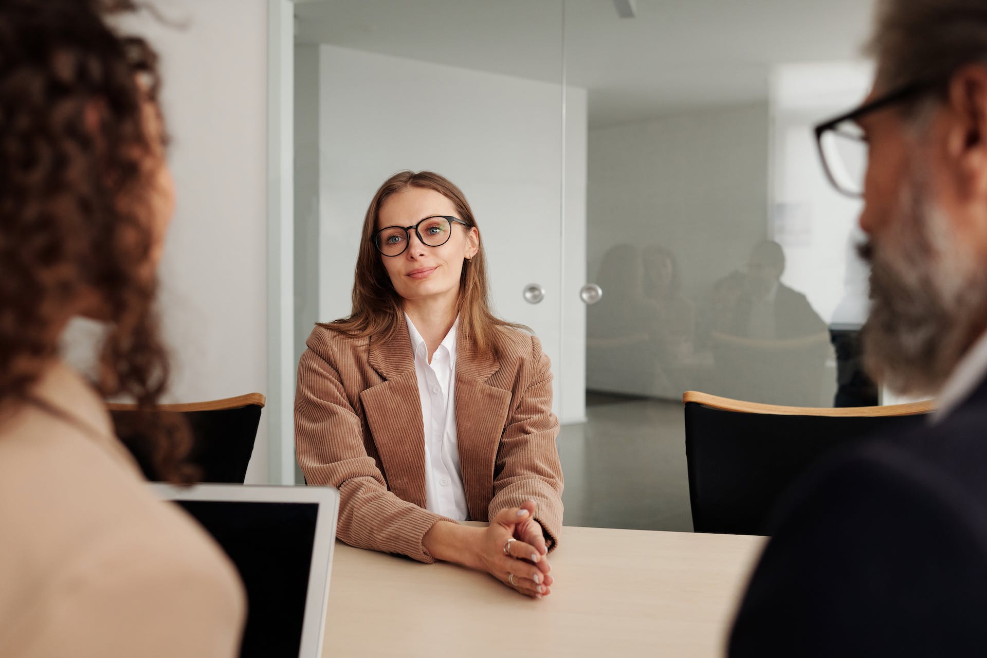 A woman sitting in front of two interviewers | Source: Pexels