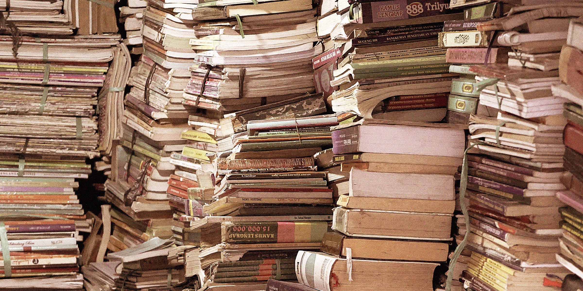 large number of stacked books | Source: Unsplash