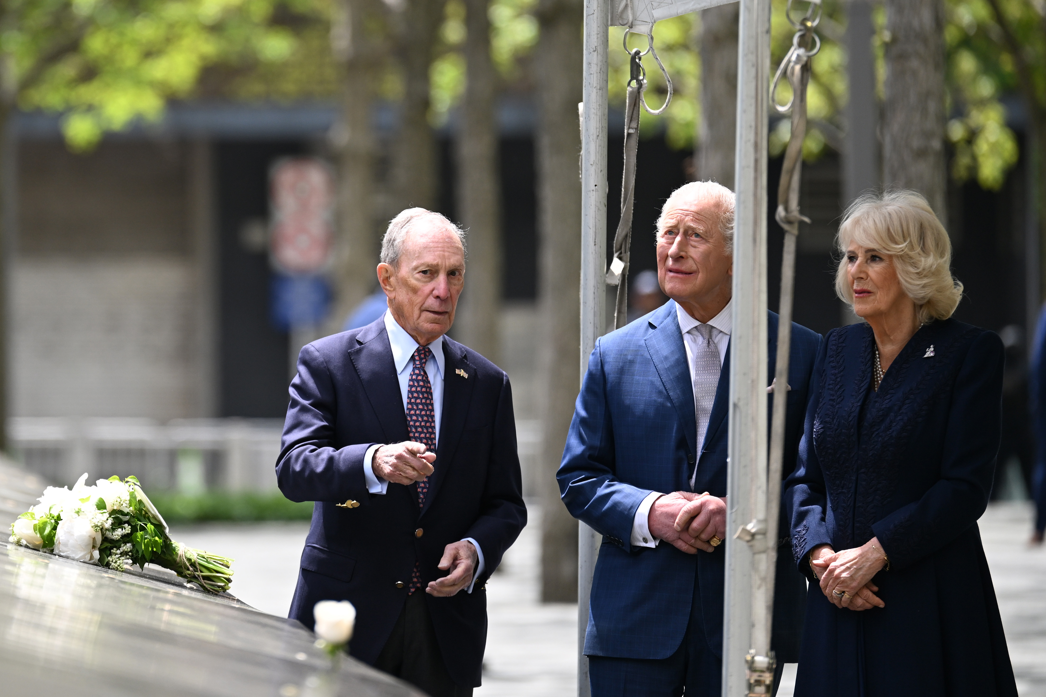 Michael Bloomberg speaks with King Charles III and Queen Camilla near the reflecting pool at the 9/11 Memorial in New York City | Source: Getty Images
