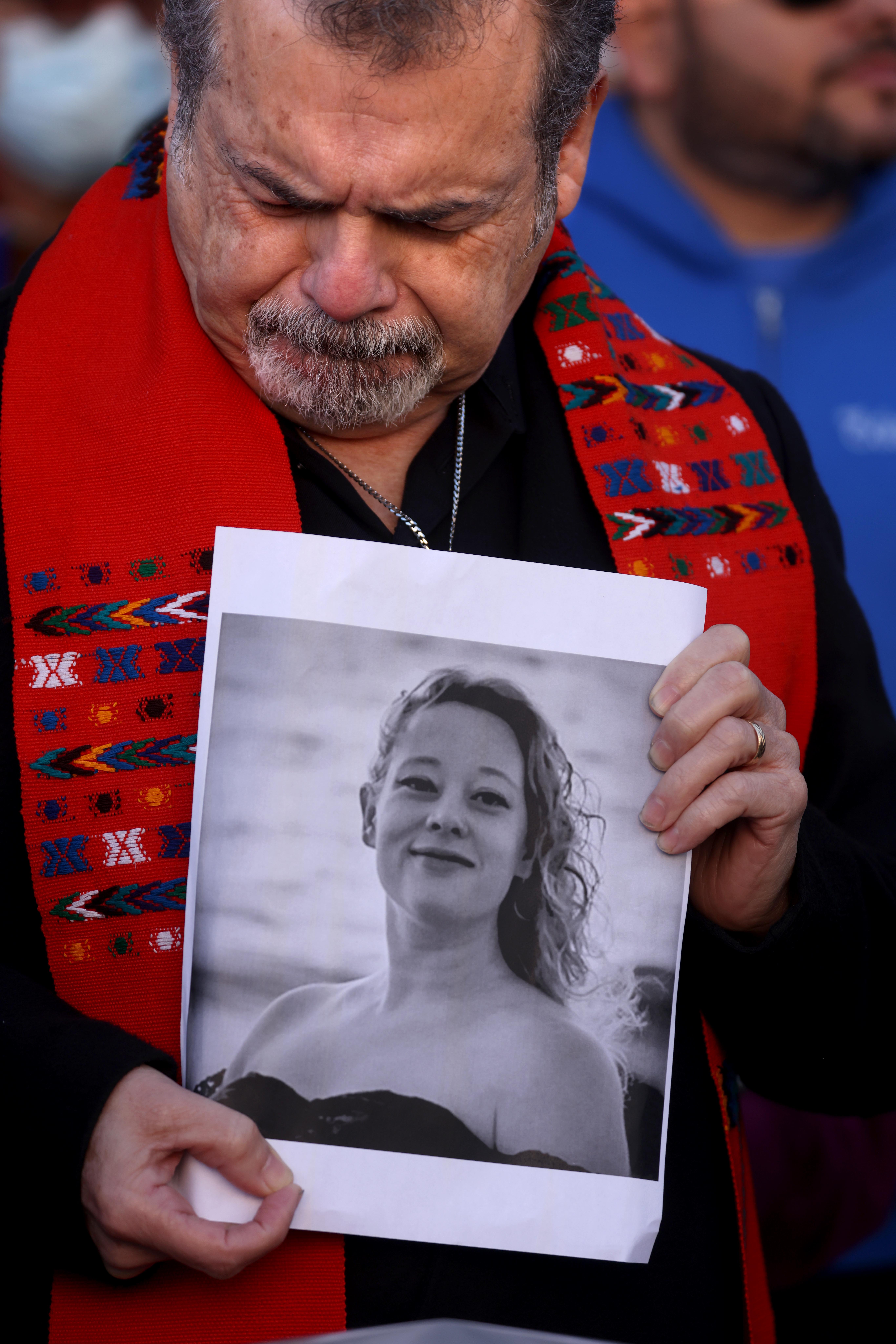 Pastor Carlos Rincon holds a photo of Renee Nicole Good, at a protest the day after her shooting, in front of the Federal Building in downtown Los Angeles on January 8, 2026 | Source: Getty Images