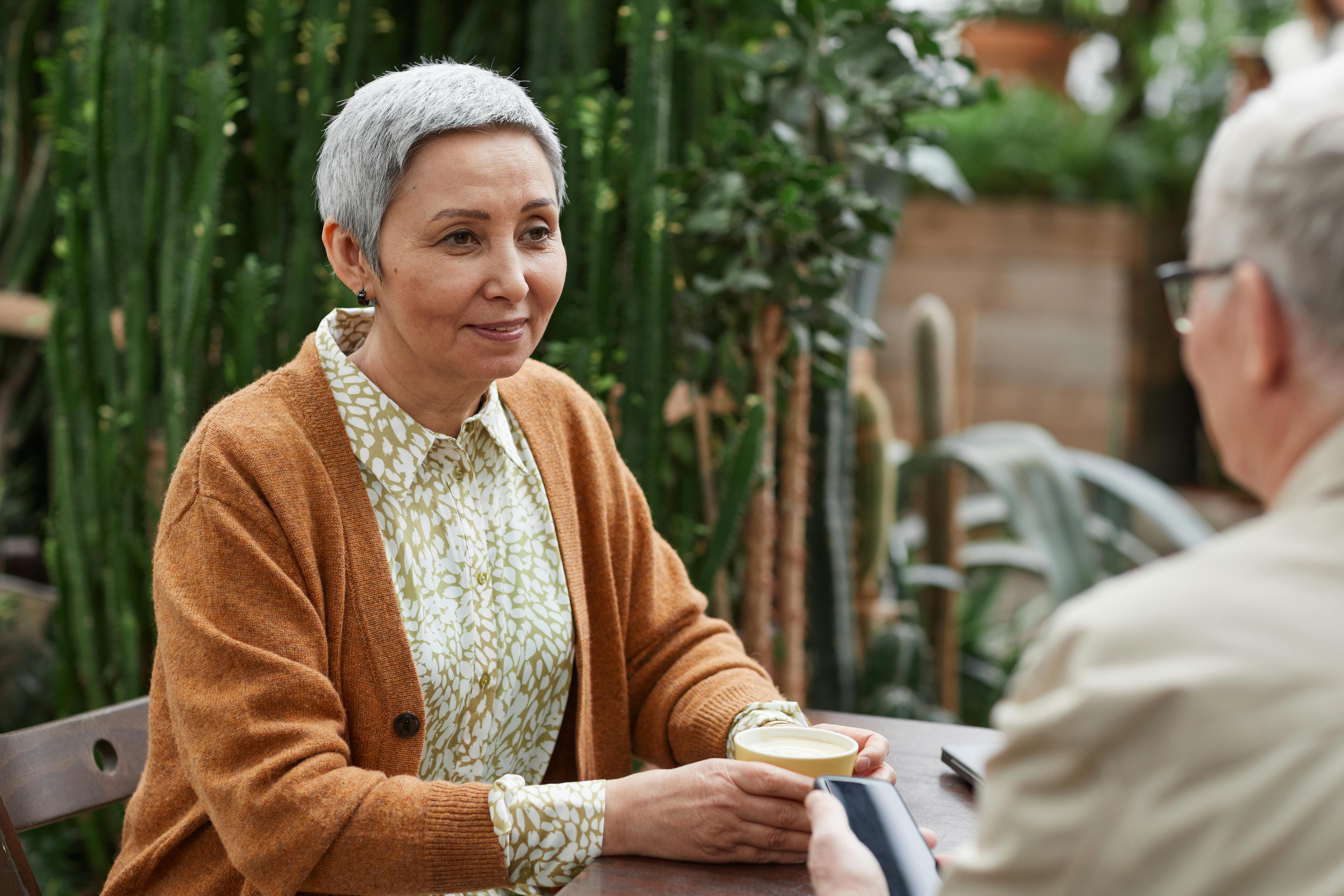 An older woman sitting at the table | Source: Pexels