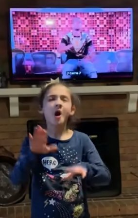 Savannah Dahan rocking out to "The Champion" by Carried Underwood feat. Ludacris. | Source: YouTube/Savvy ASL