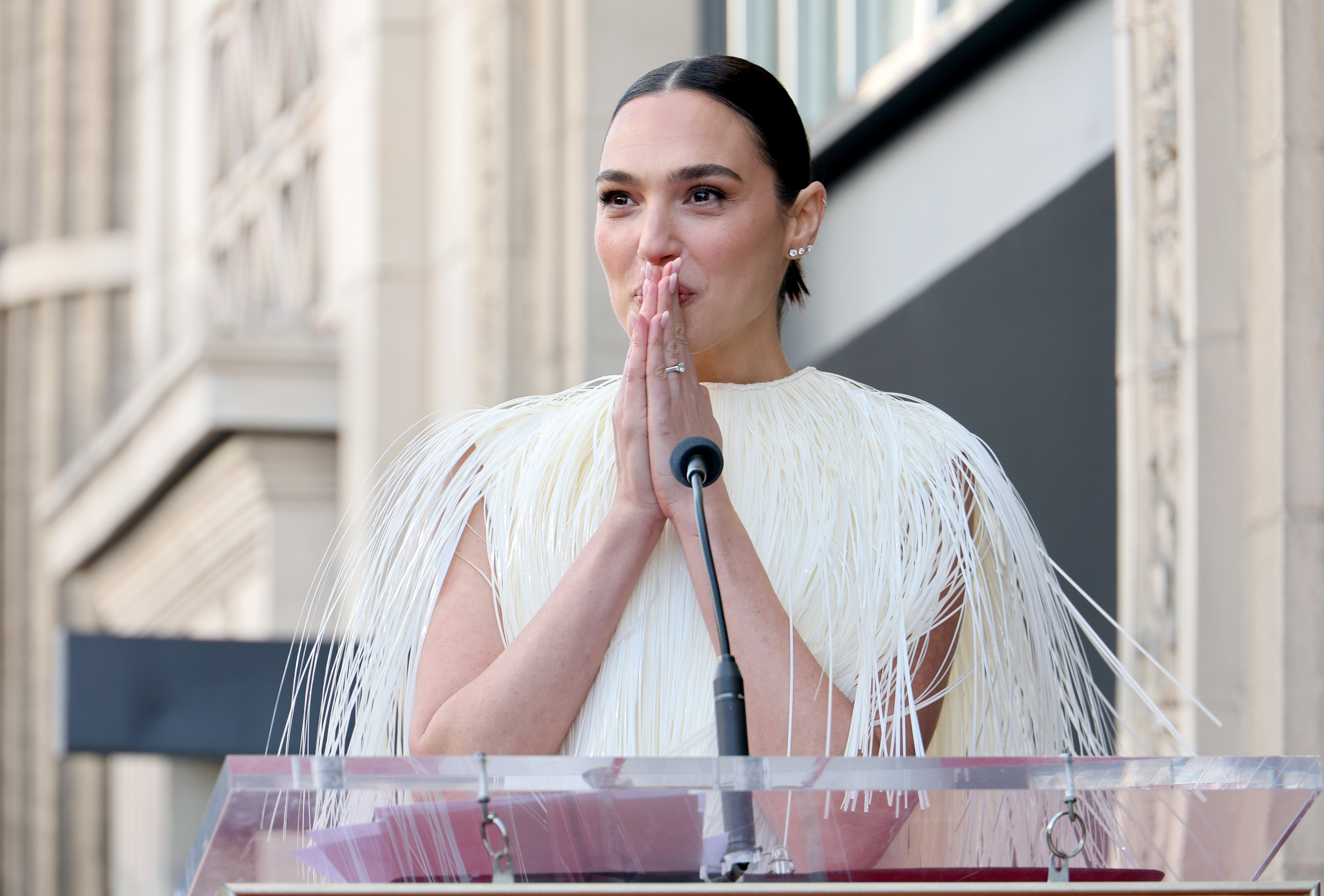 Gal Gadot is overwhelmed while standing onstage during the ceremony honoring her with a Star on the Hollywood Walk of Fame on March 18, 2025, in Hollywood, California | Source: Getty Images