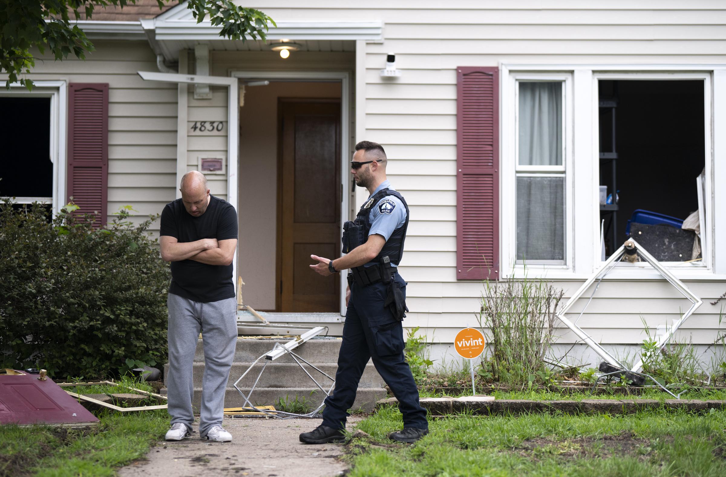 Vance Boelter's roommate, who declined to give his name, speaks with a Minneapolis police officer outside his home on June 14, 2025 in Minneapolis, Minnesota. | Source: Getty Images