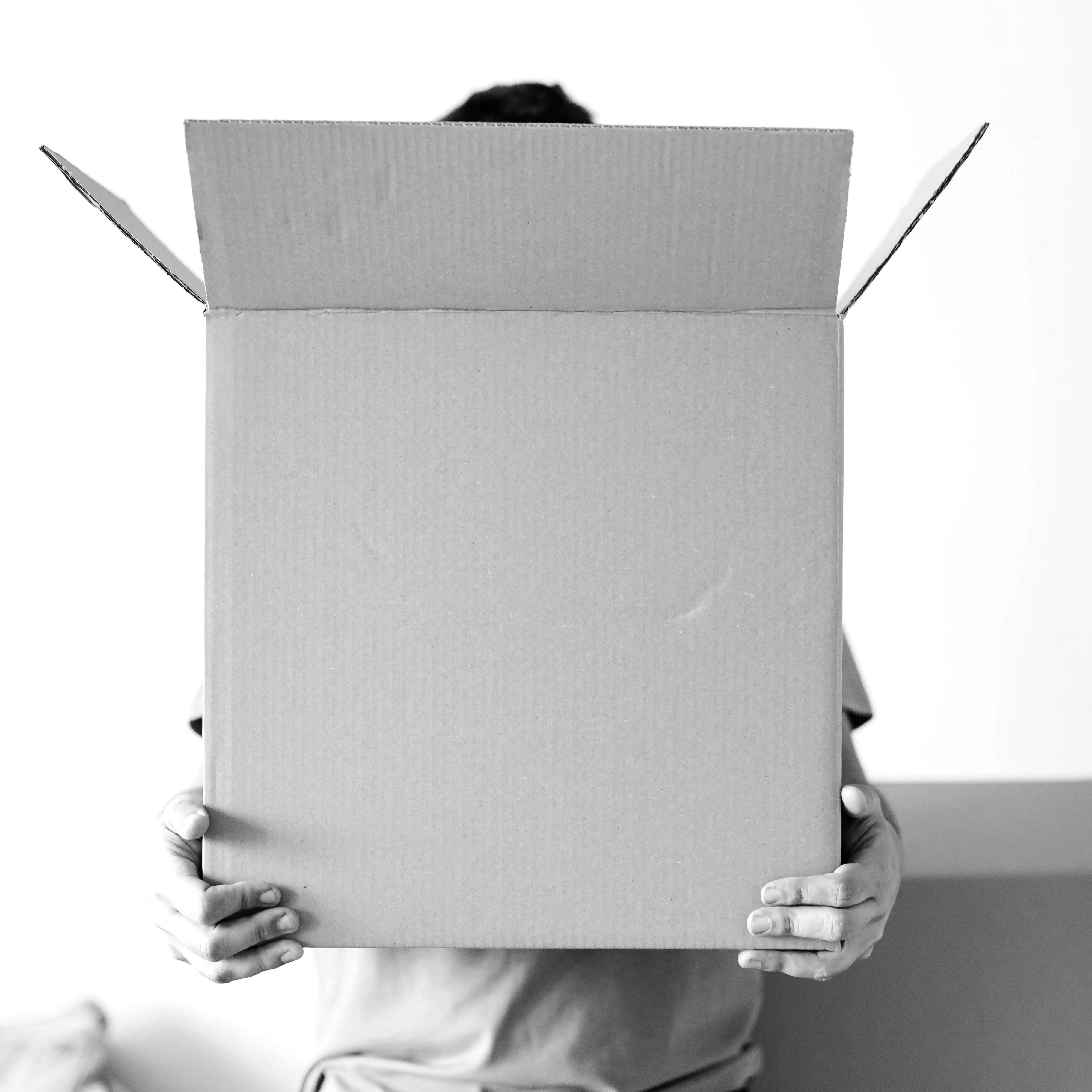 A man carrying a large box | Source: Pexels