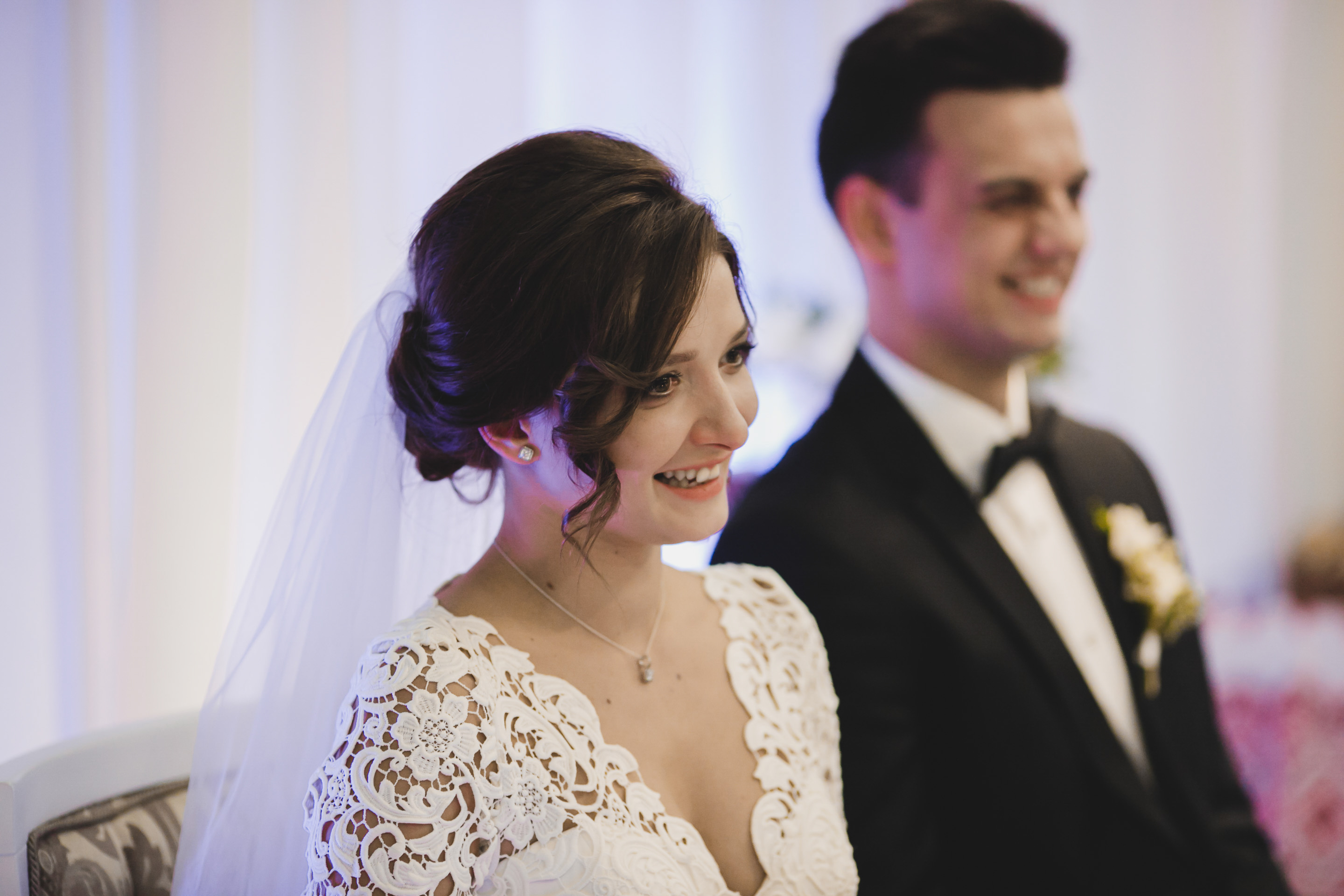 A young couple smiling on their wedding day | Source: Shutterstock