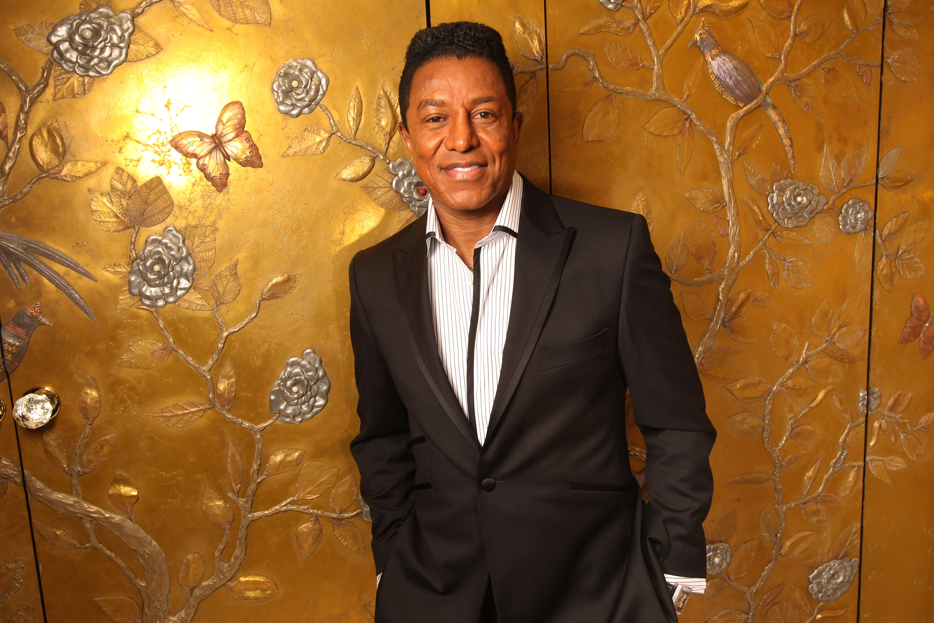 Jermaine Jackson posing for a portrait after getting fitted for a suit by Savile Row tailor Gary Anderson at The Dorchester Hotel on December 12, 2011, in London, England. | Source: Getty Images