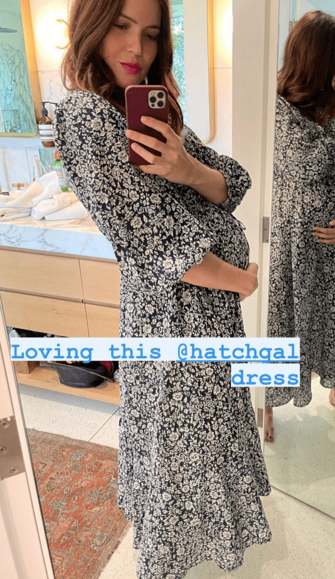 Mandy Moore cradling her bump in a black and white floral patterned ankle-length gown on her Instagram story | Photo: Instagram / mandymooremm