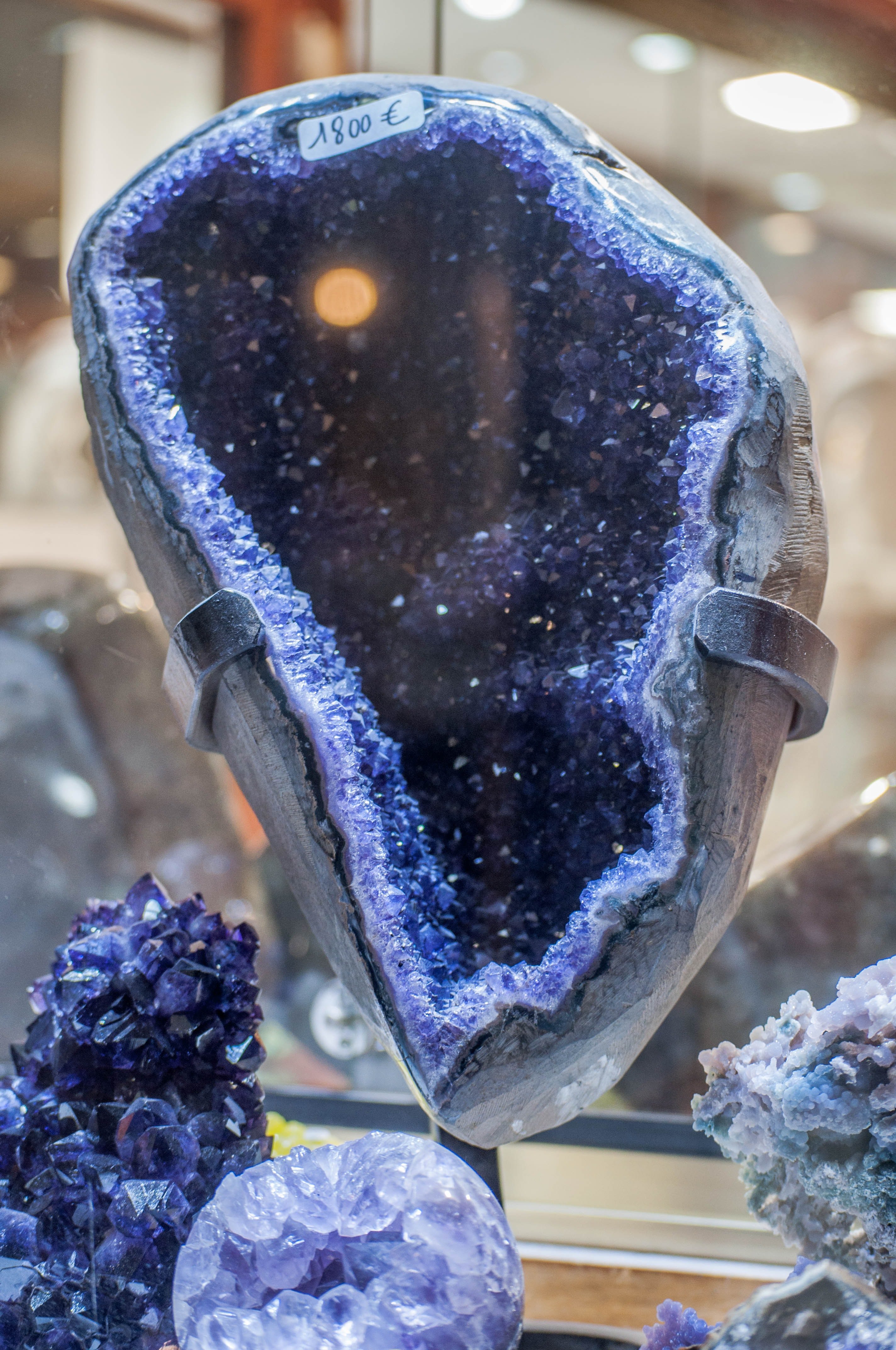 A large blue gem is displayed in a glass cabinet | Photo: Unsplash/Sophie Louisnard