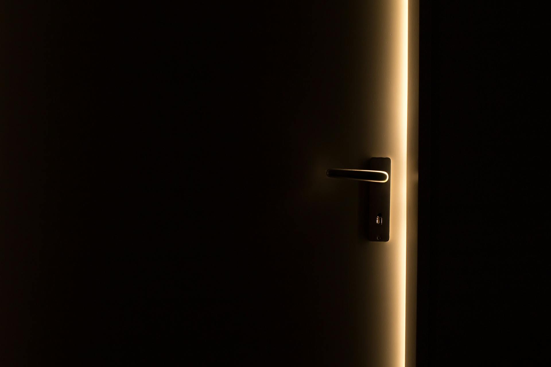 A door slightly open with light streaming in | Source: Pexels