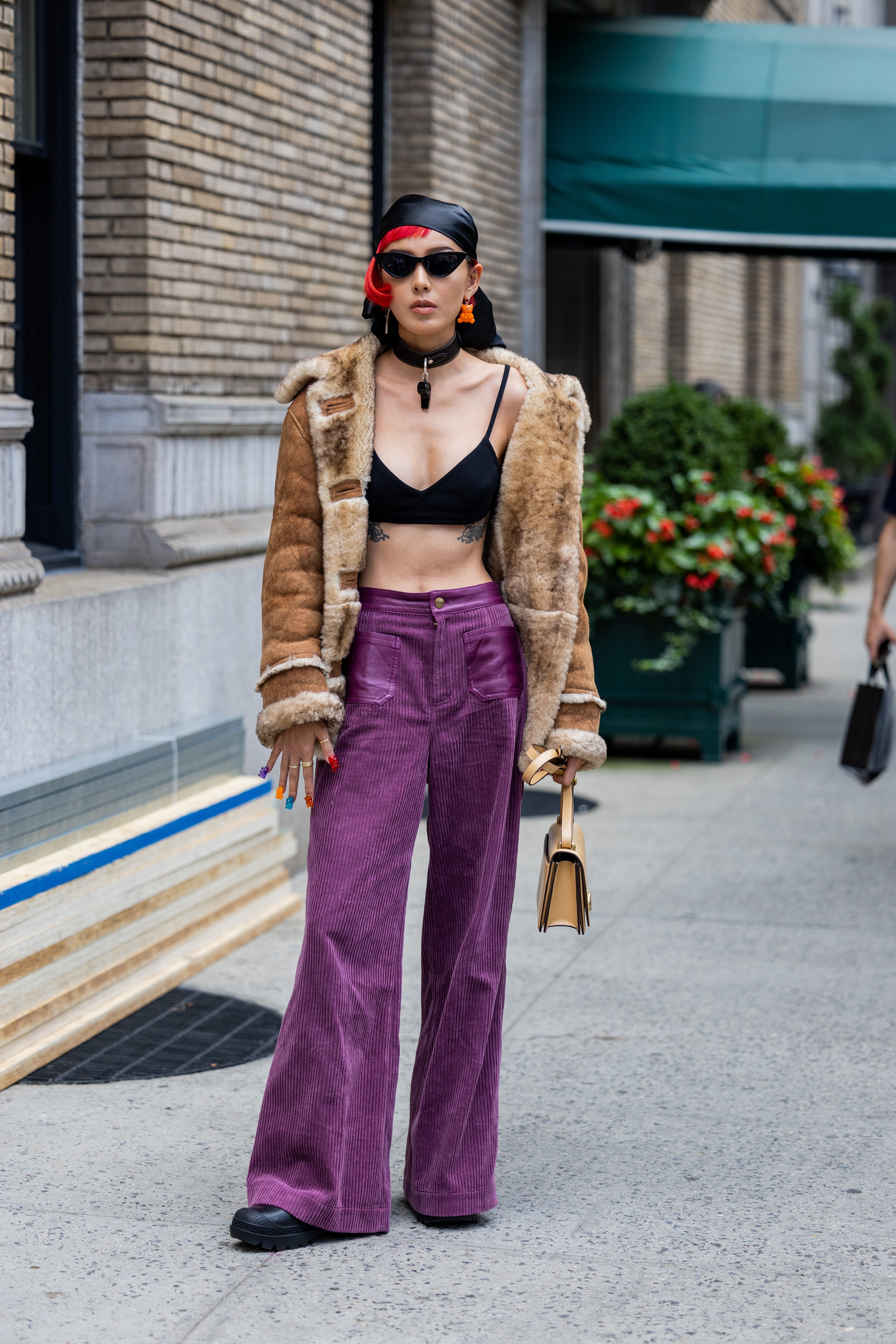A woman photographed wearing purple corduroy pants on the streets of New York on on September 12, 2022. | Source: Getty Images