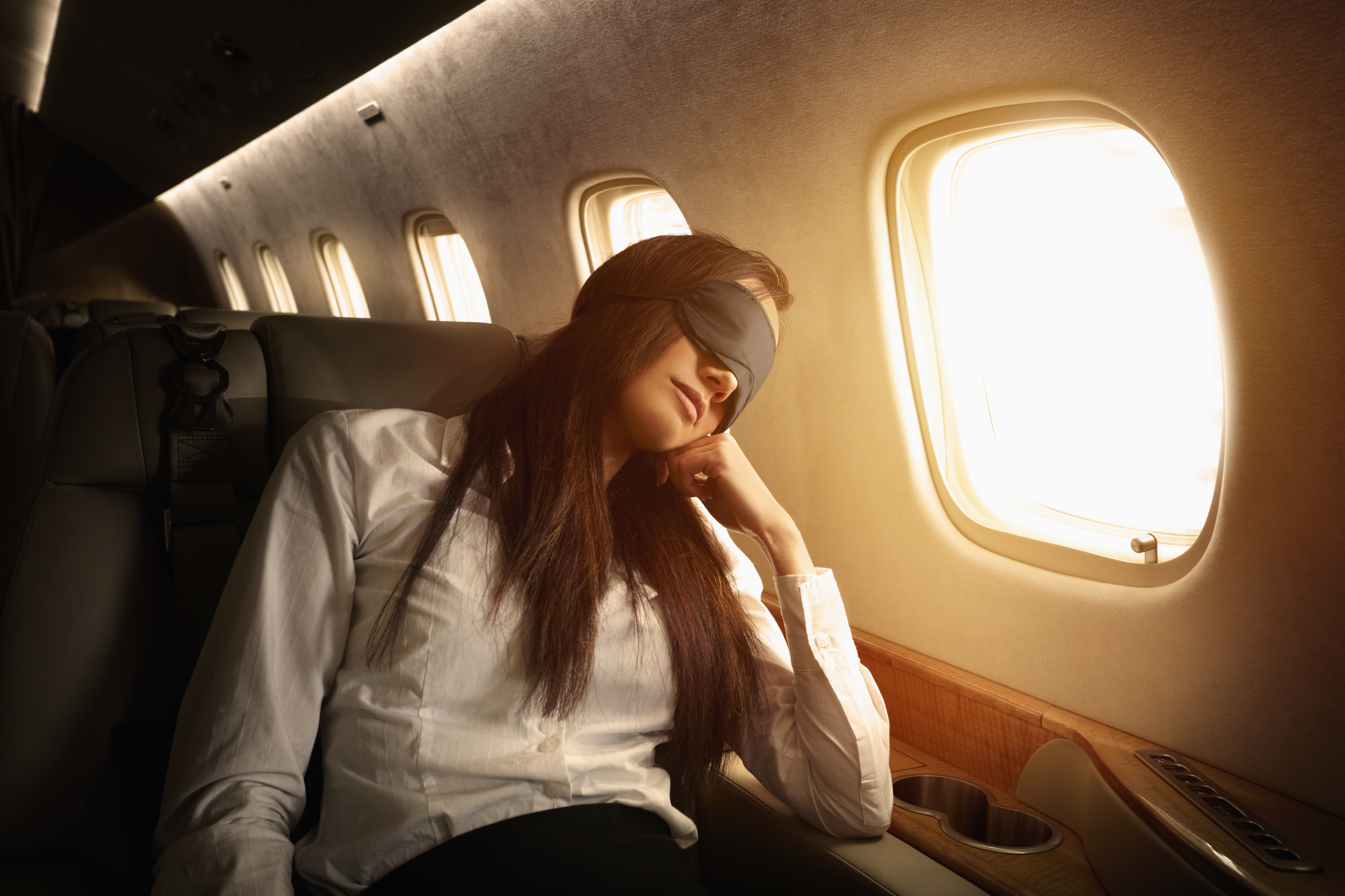 Pacific Islander businesswoman sleeping on private jet | Source: Getty Images