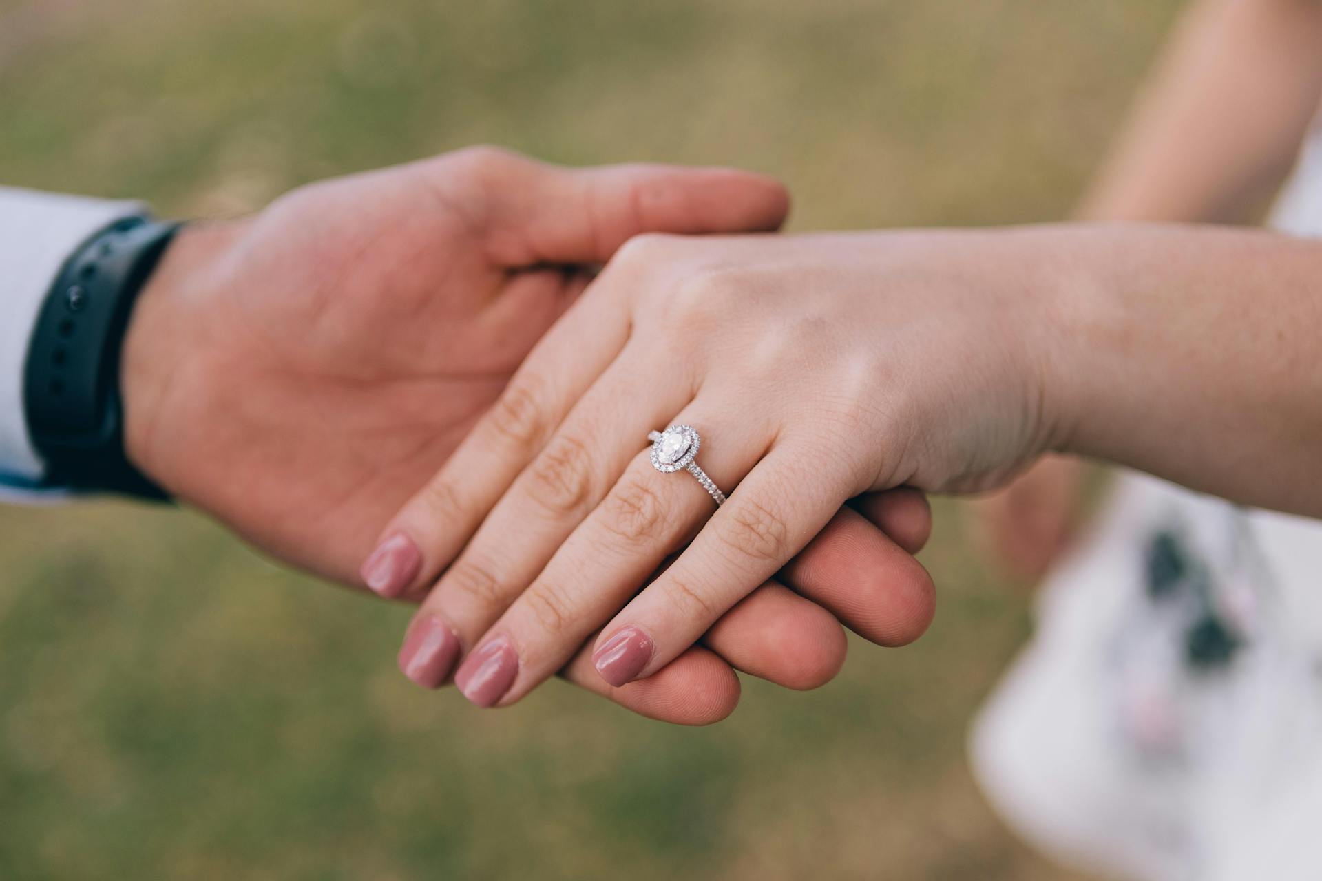 A man holding his fiancée's hand showing her engagement ring | Source: Pexels