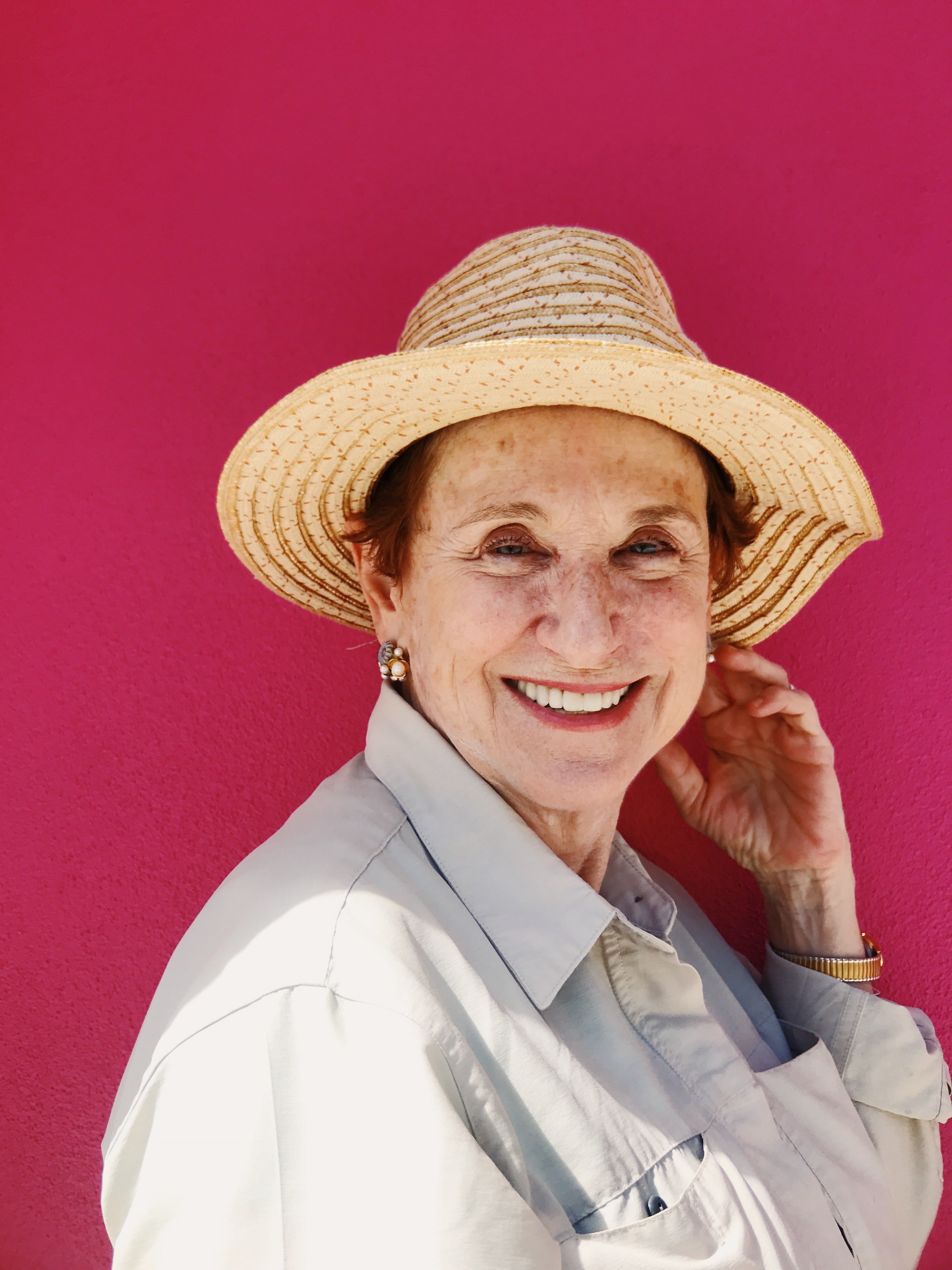 Smiling woman wearing a hat | Source: Unsplash