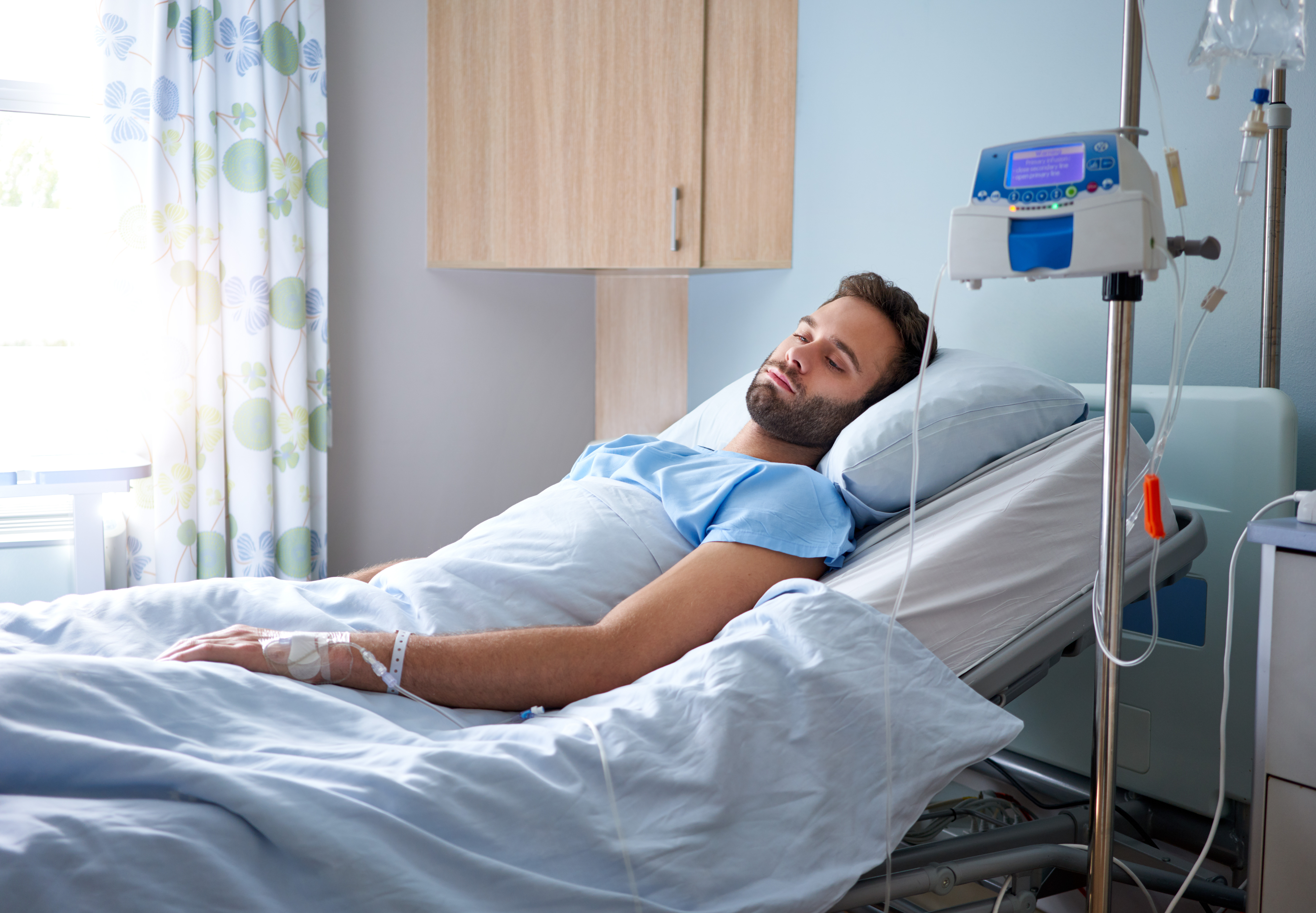 A man in a hospital bed | Source: Shutterstock