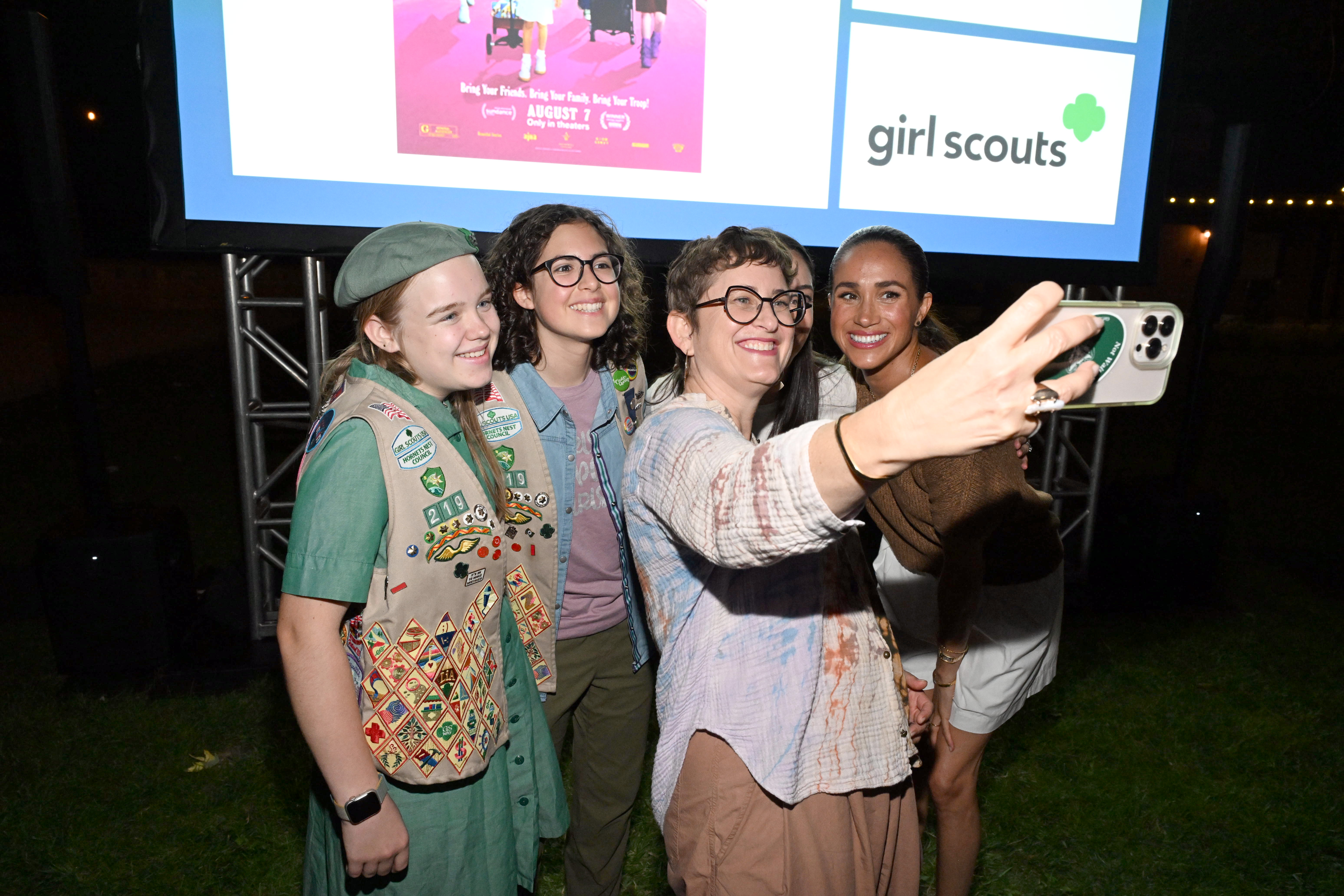 Meghan Markle smiles for a selfie with filmmaker Alysa Nahmias and Girl Scouts during the "Cookie Queens" screening at Camp Arnaz in Ojai, California, on July 29, 2026. | Source: Getty Images