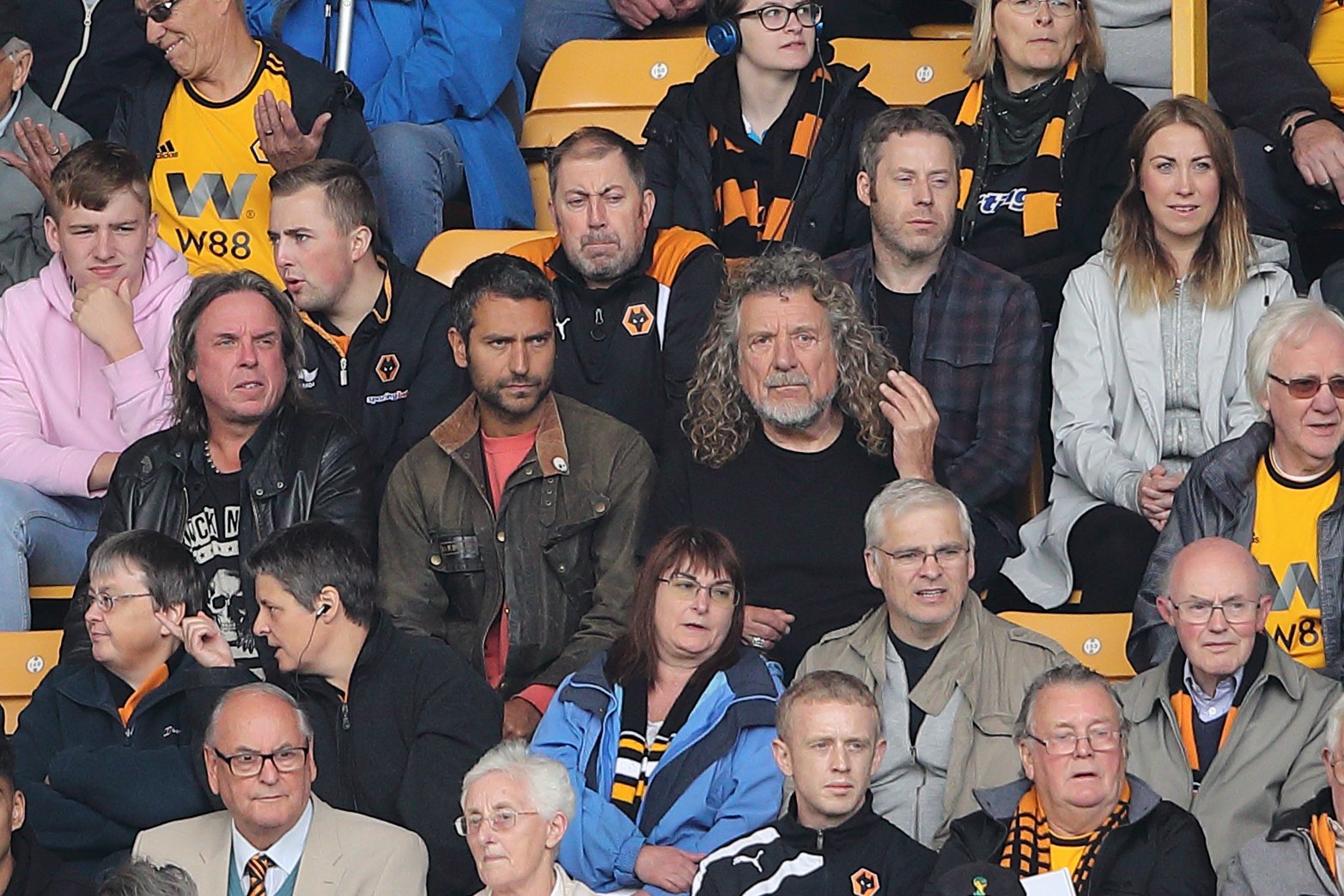 Logan Plant and Robert Plant in the middle of the seating area at a Premier League match on August 25, 2018, in Wolverhampton | Source: Getty Images