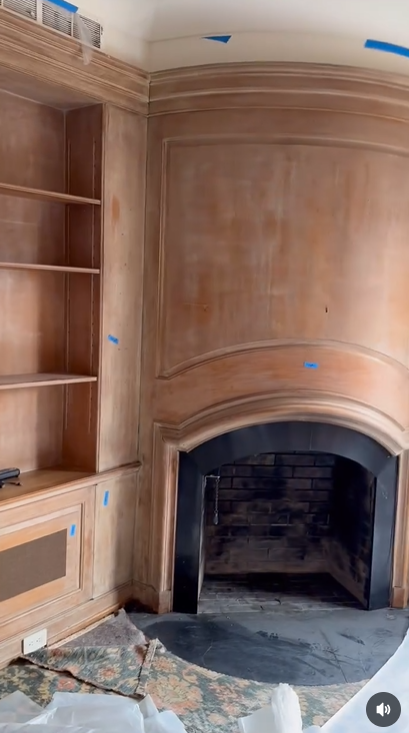 A bowed fireplace and full wood paneling in the home's library, one of the most distinctive architectural features saved | Source: Instagram/hudsonvalleyhouseparts