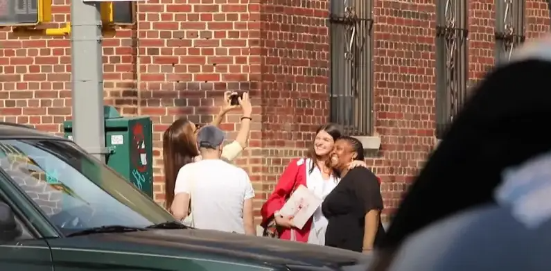 Katie Holmes taking pictures of her daughter on her graduation day. | Source: YouTube/ Page Six
